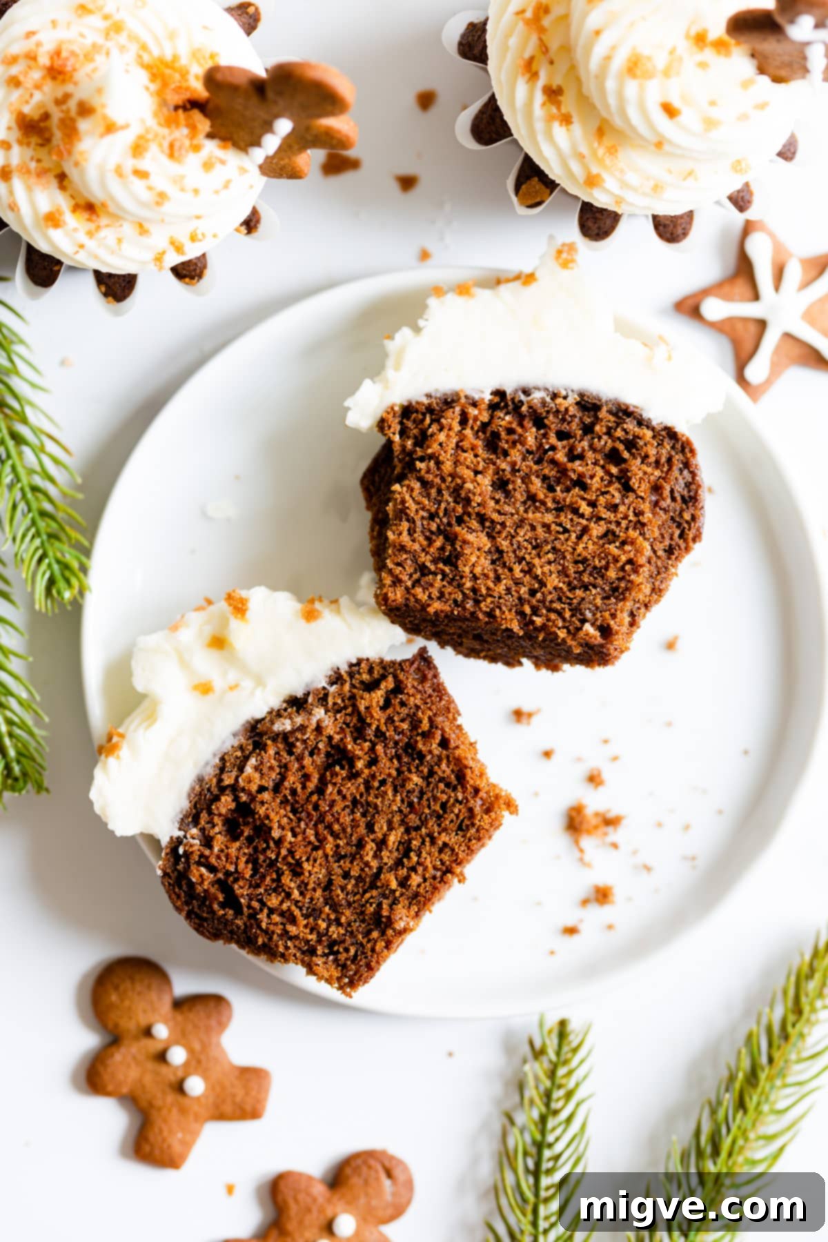 Holiday Gingerbread Delights with Cream Cheese Clouds 8 top view close up of a gingerbread cupcake with cream cheese frosting cut in half