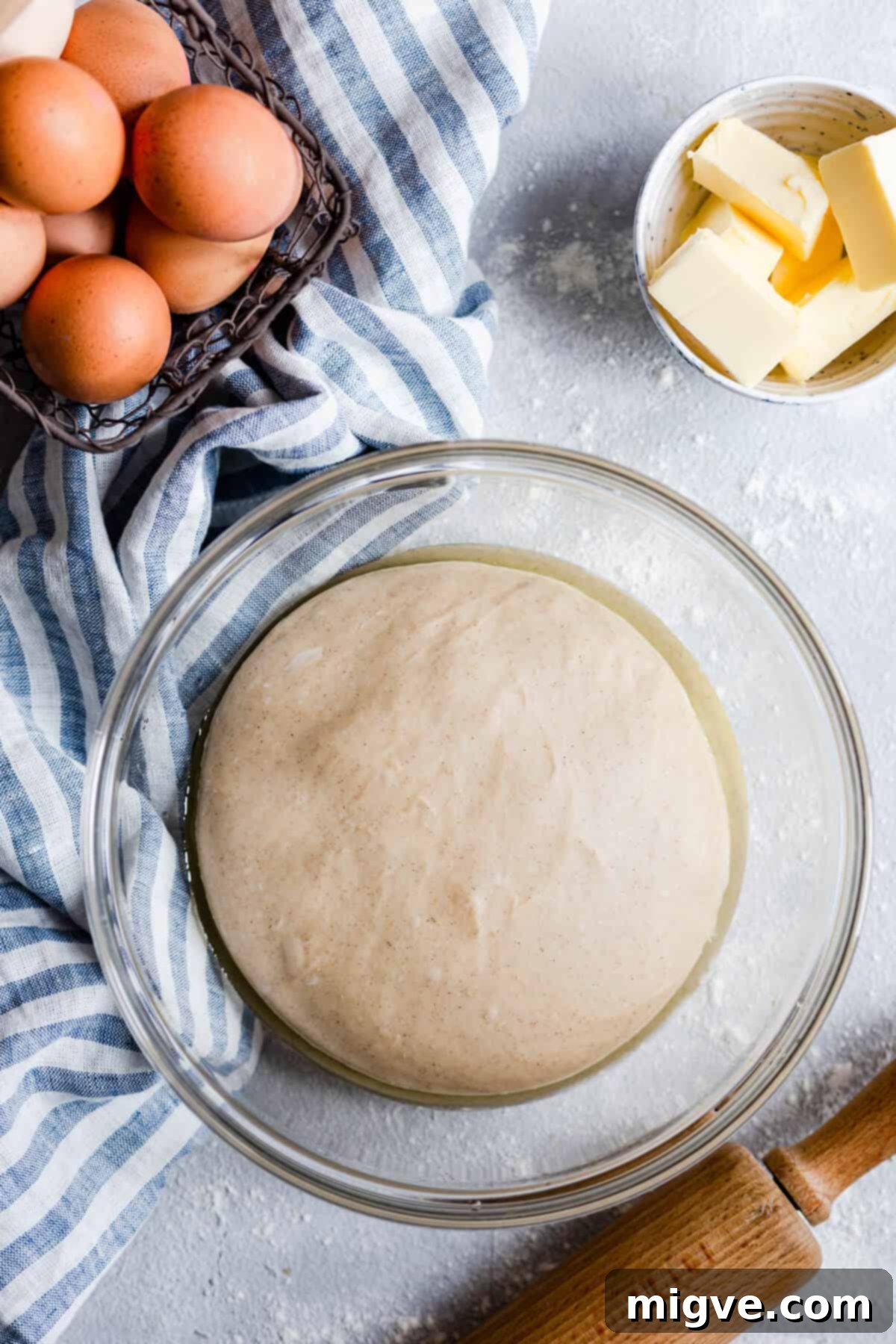 An overhead shot of a bowl filled with perfectly risen, smooth dough, ready for shaping.