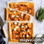 Top view of a beautifully sliced butternut squash tart, garnished with fresh rosemary, ready to be served