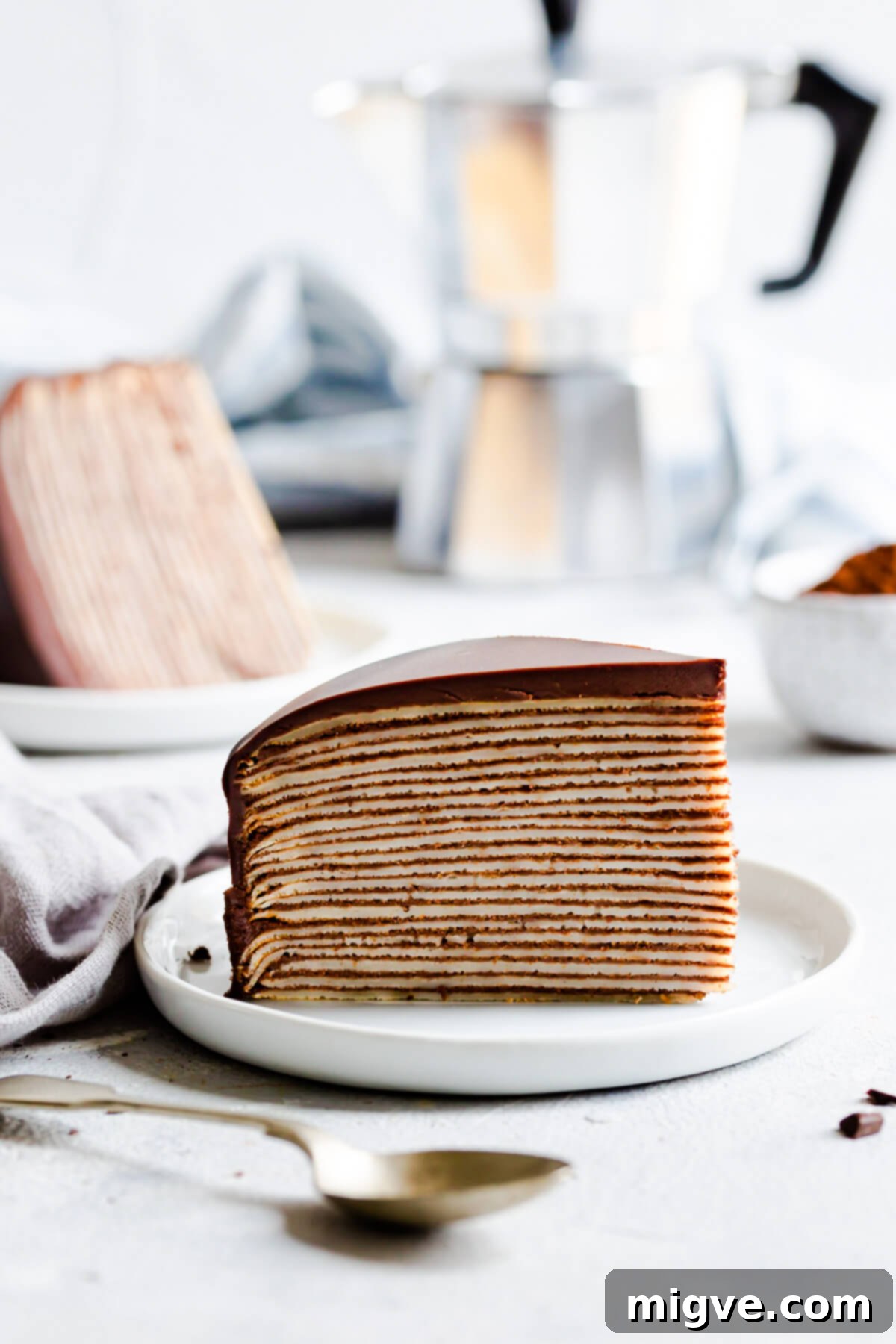Decadent Chocolate Crepe Dream 2 side view of a slice of crepe cake on a small plate
