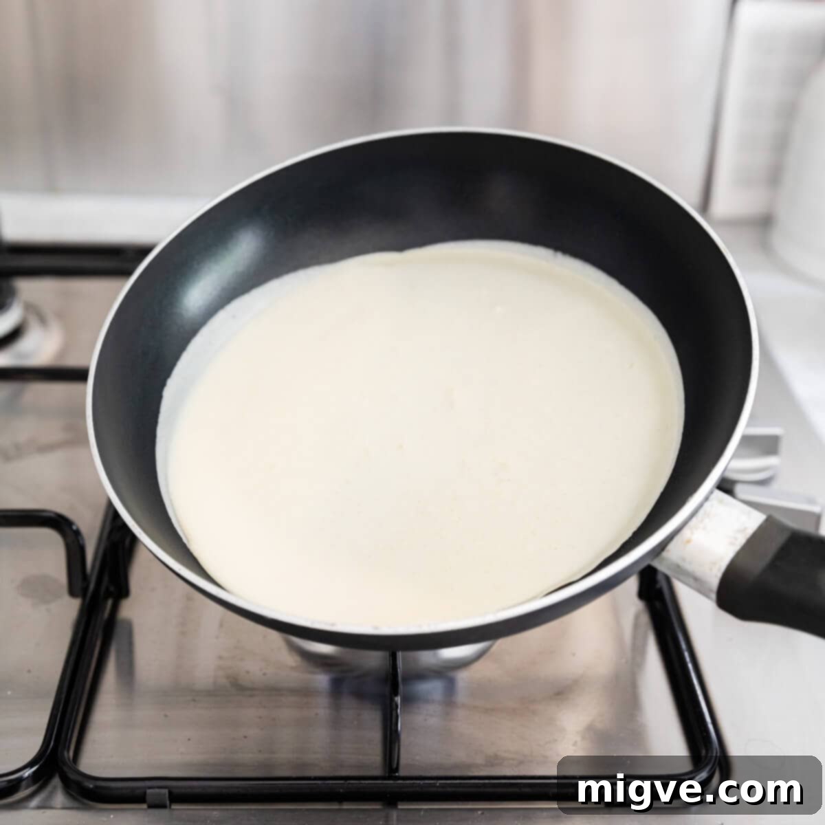 Decadent Chocolate Crepe Dream 5 side angle view at crepe batter poured into frying pan