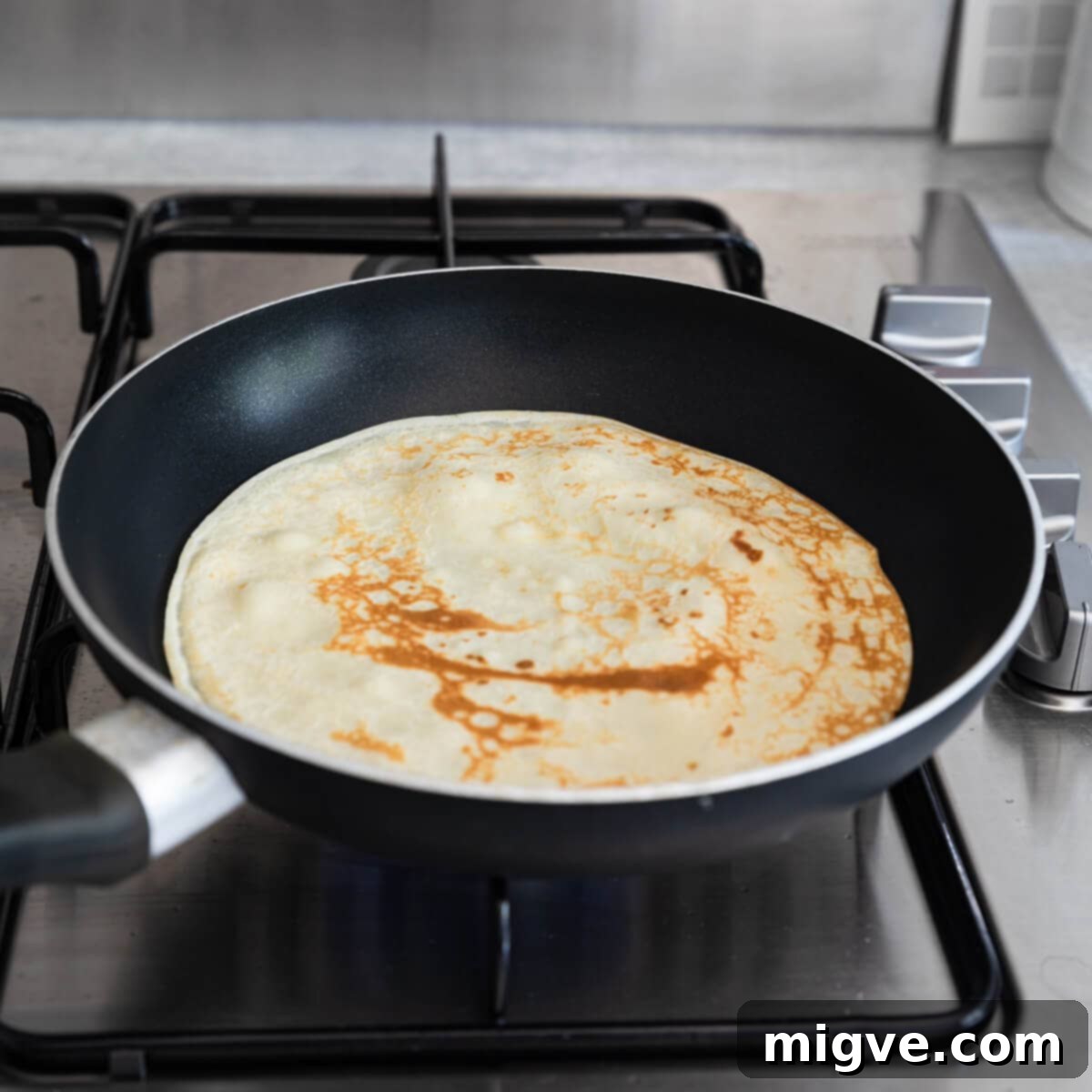 Decadent Chocolate Crepe Dream 6 45 degree angle view at frying pan with crepe