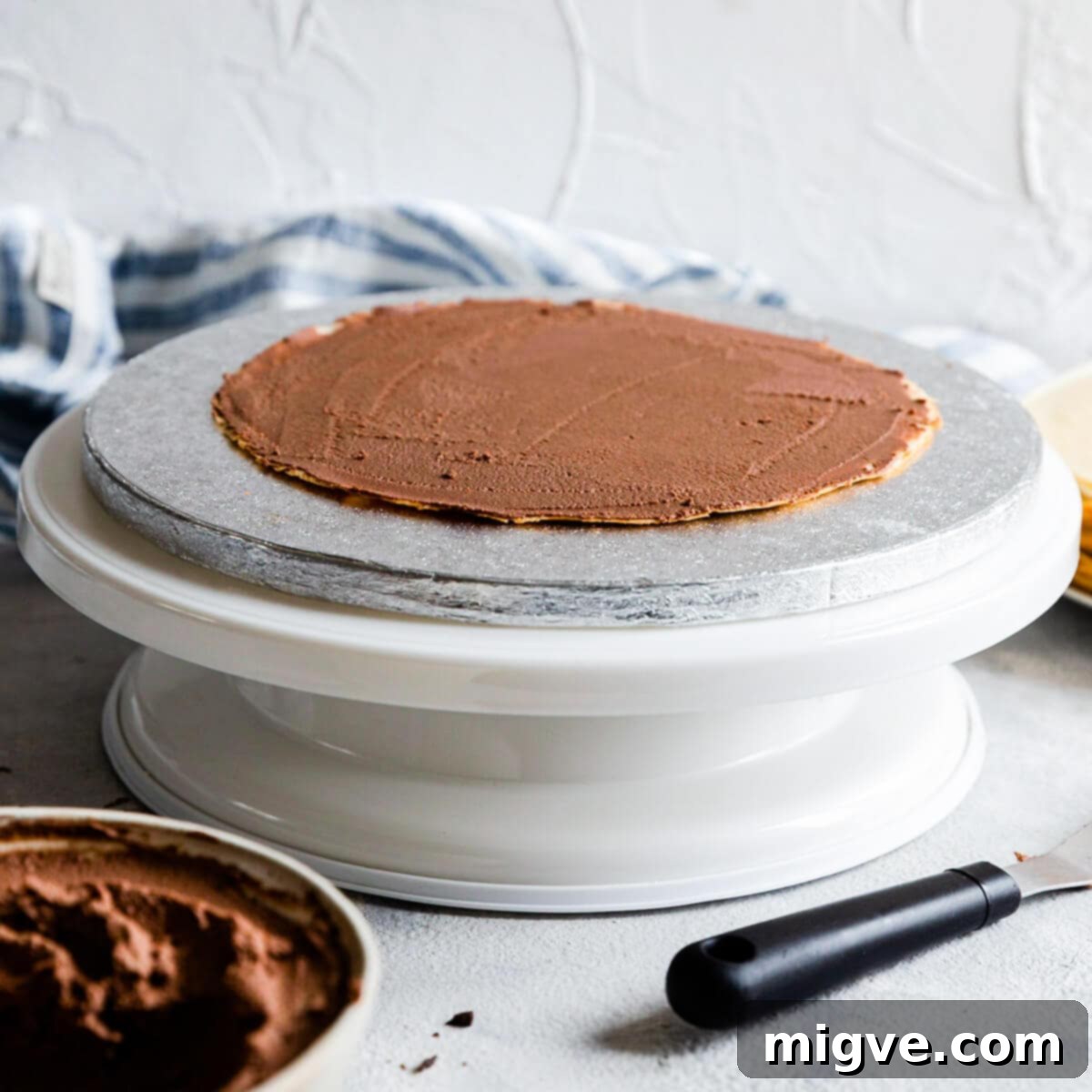 Decadent Chocolate Crepe Dream 8 close up of the first crepe topped with cream on a cake board