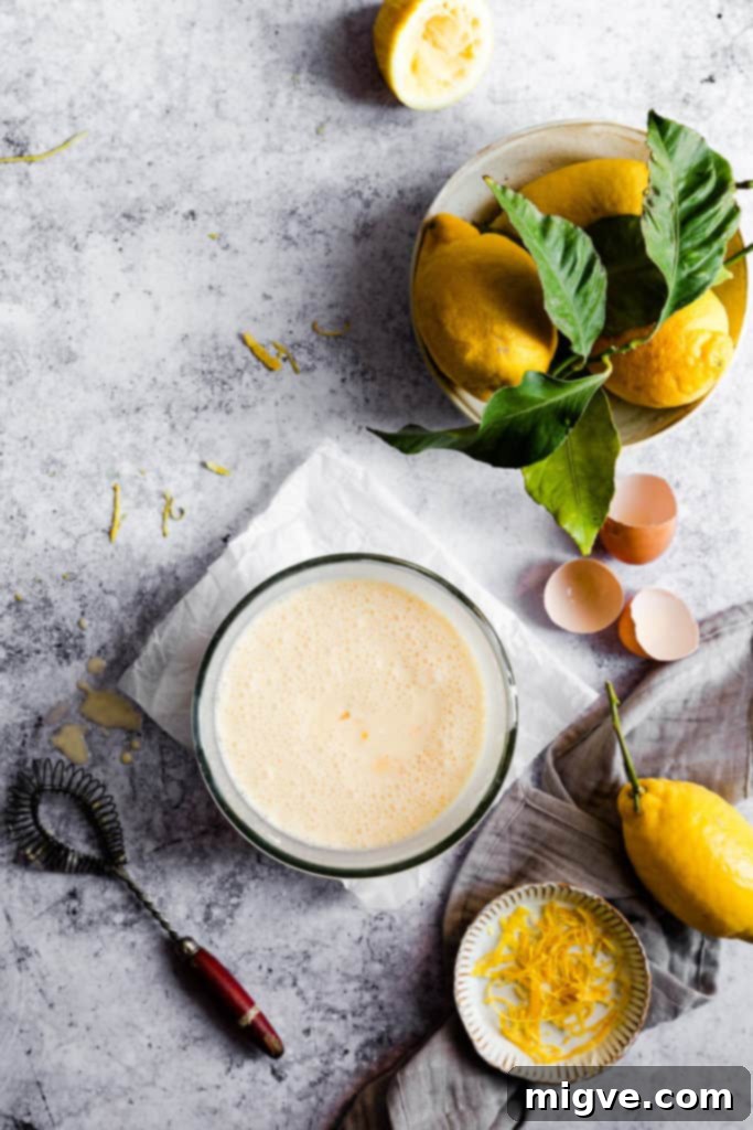 Eggs and cream being whisked together in a bowl for the lemon pie filling.