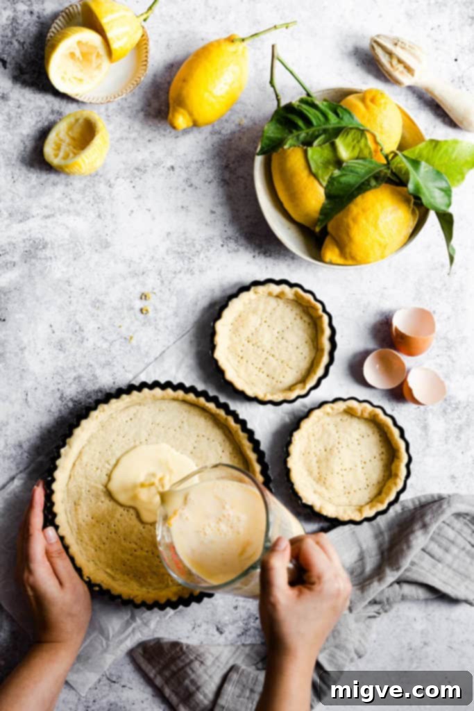 Lemon zest being added to the sieved egg and cream mixture for the filling.
