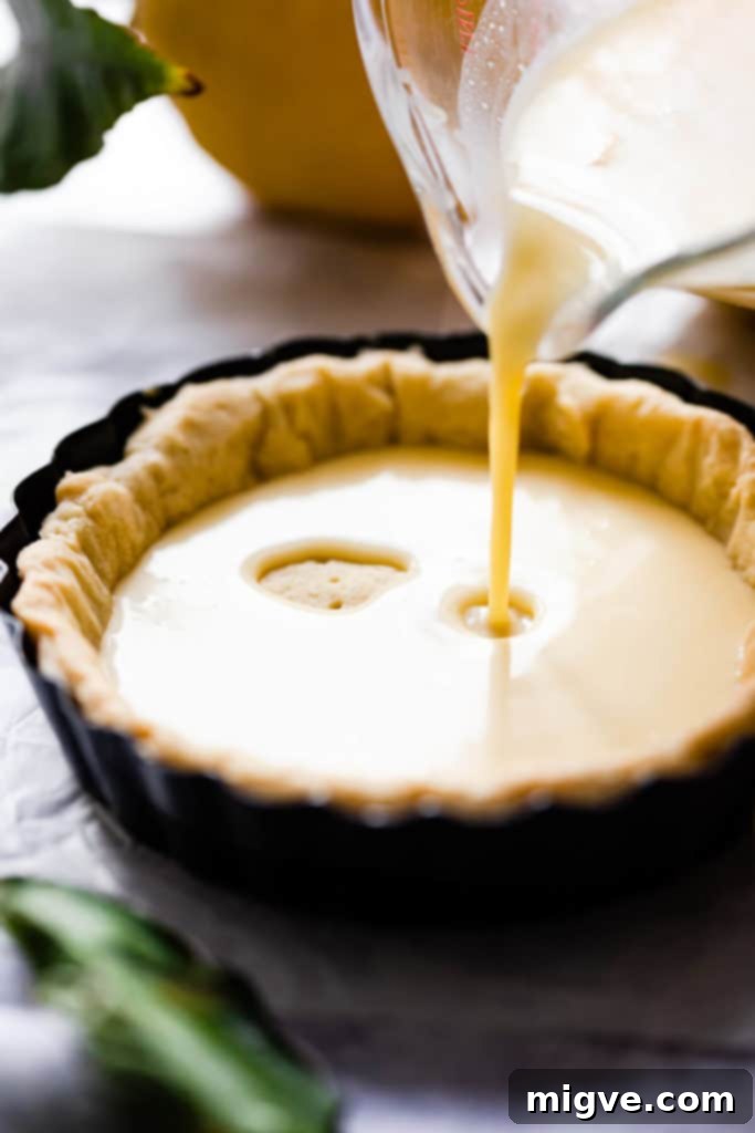 The smooth, prepared lemon filling mixture in a bowl, ready to be poured into the pie crust.