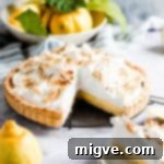 side view of a lemon pie with a slice cut out