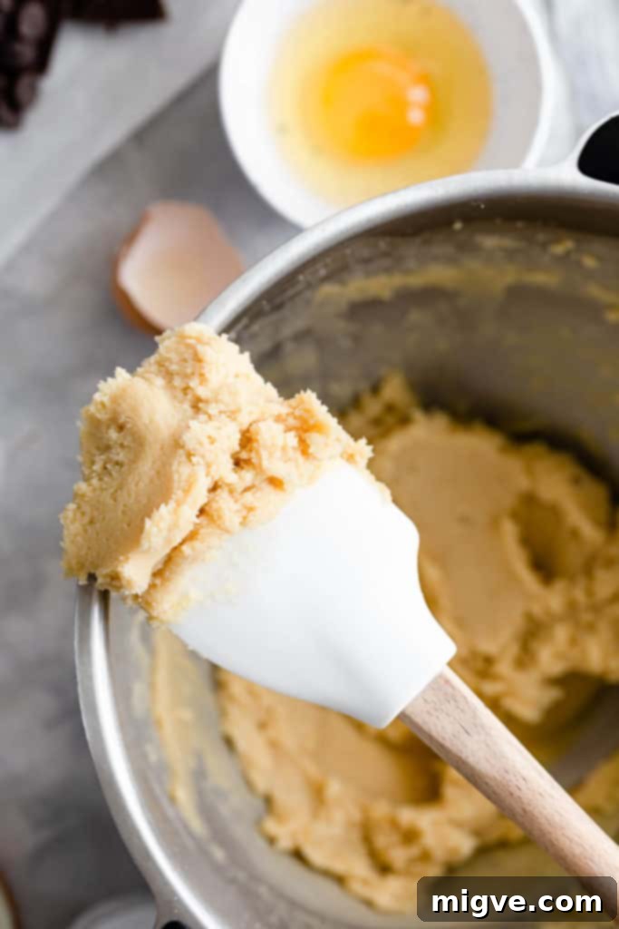 close up from top of a spatula with butter and sugar mixture, showing its fluffy texture