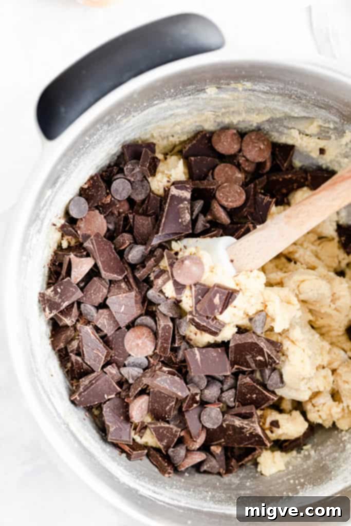 close up of the bowl with cookie dough and chocolate chips, ready for mixing