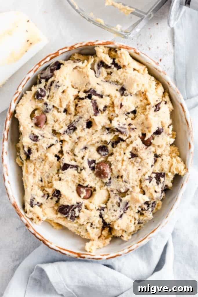 top view of a bowl with cookie dough with chocolate, evenly distributed