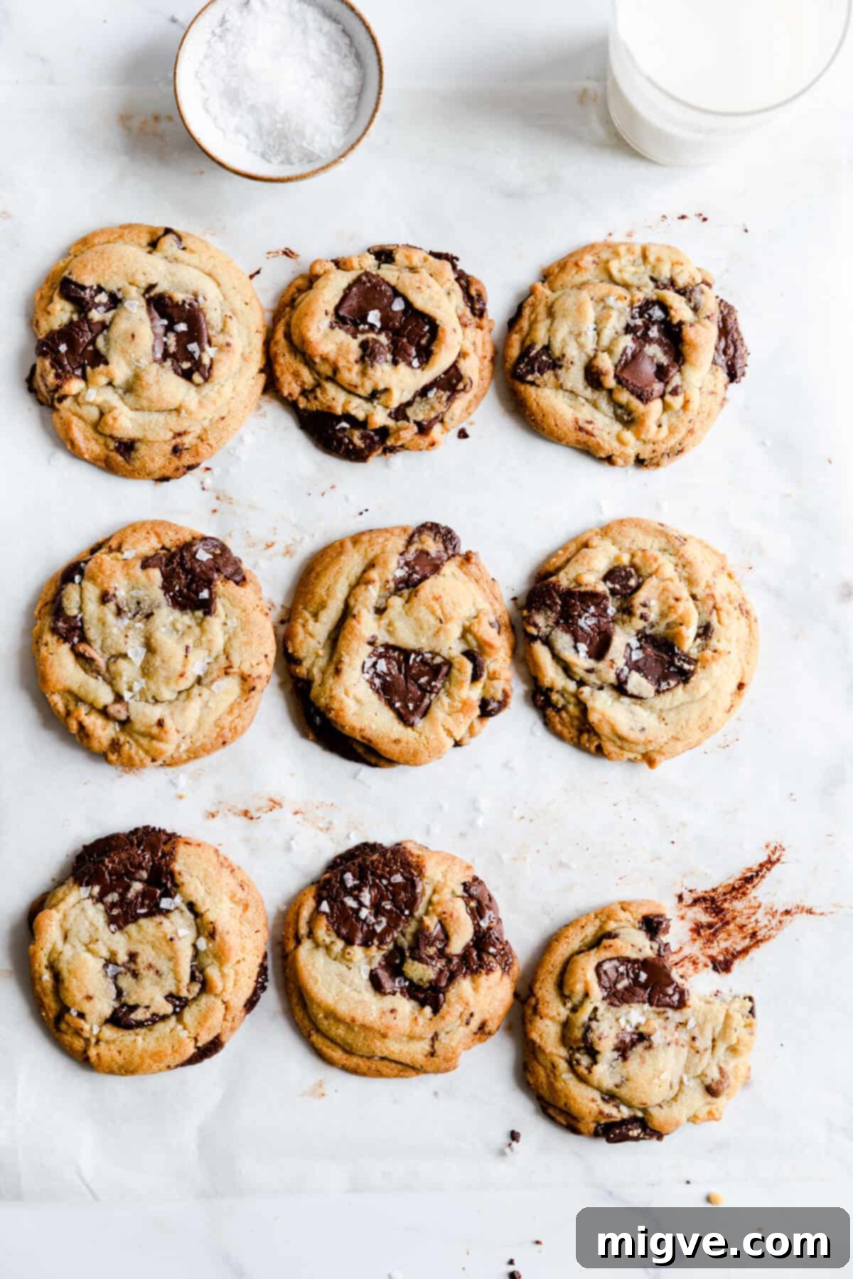 top view of 9 chocolate chip cookies on a baking tray, showing their golden color