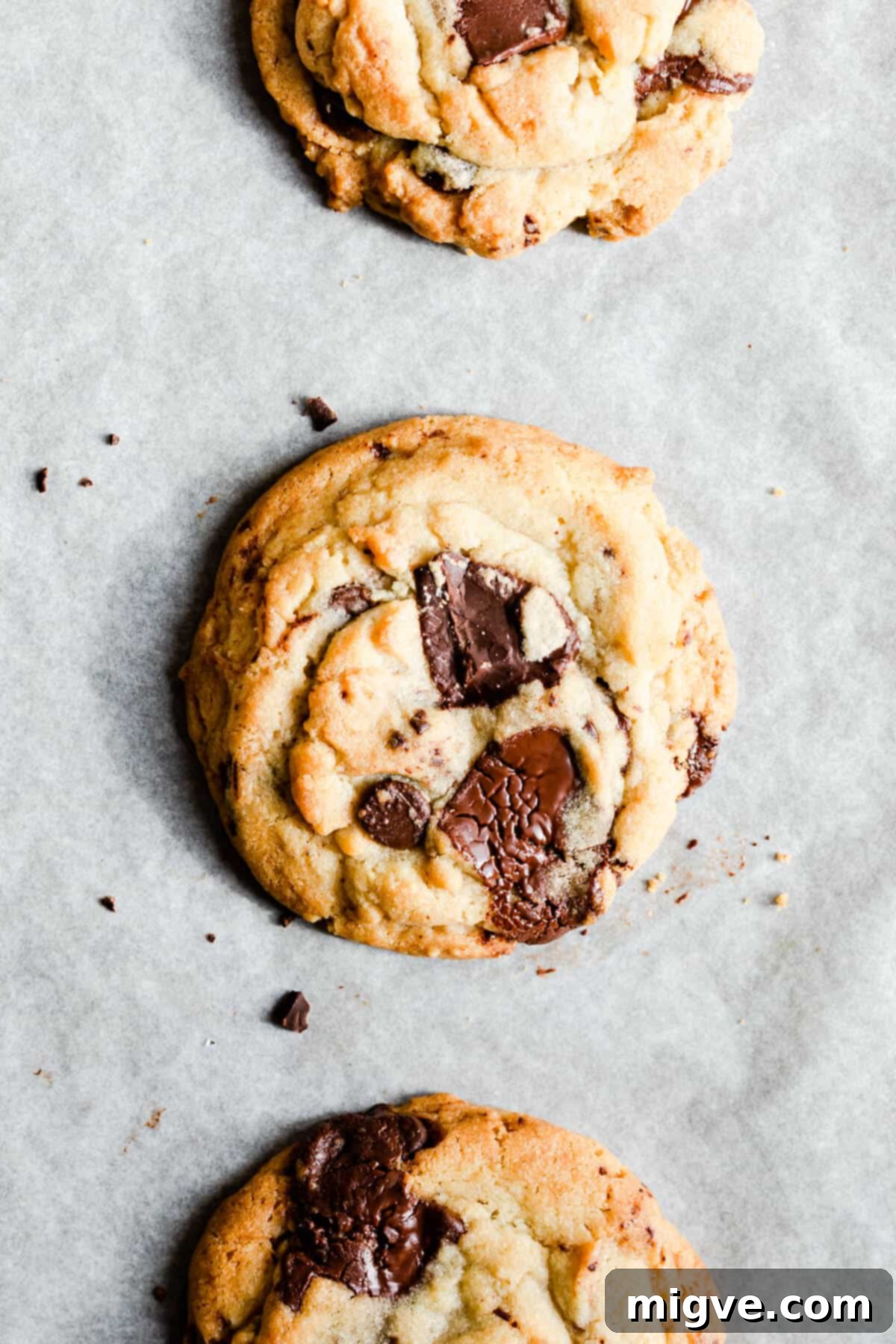 close up from top of a baked cookie with chocolate chips, showcasing the melted chocolate