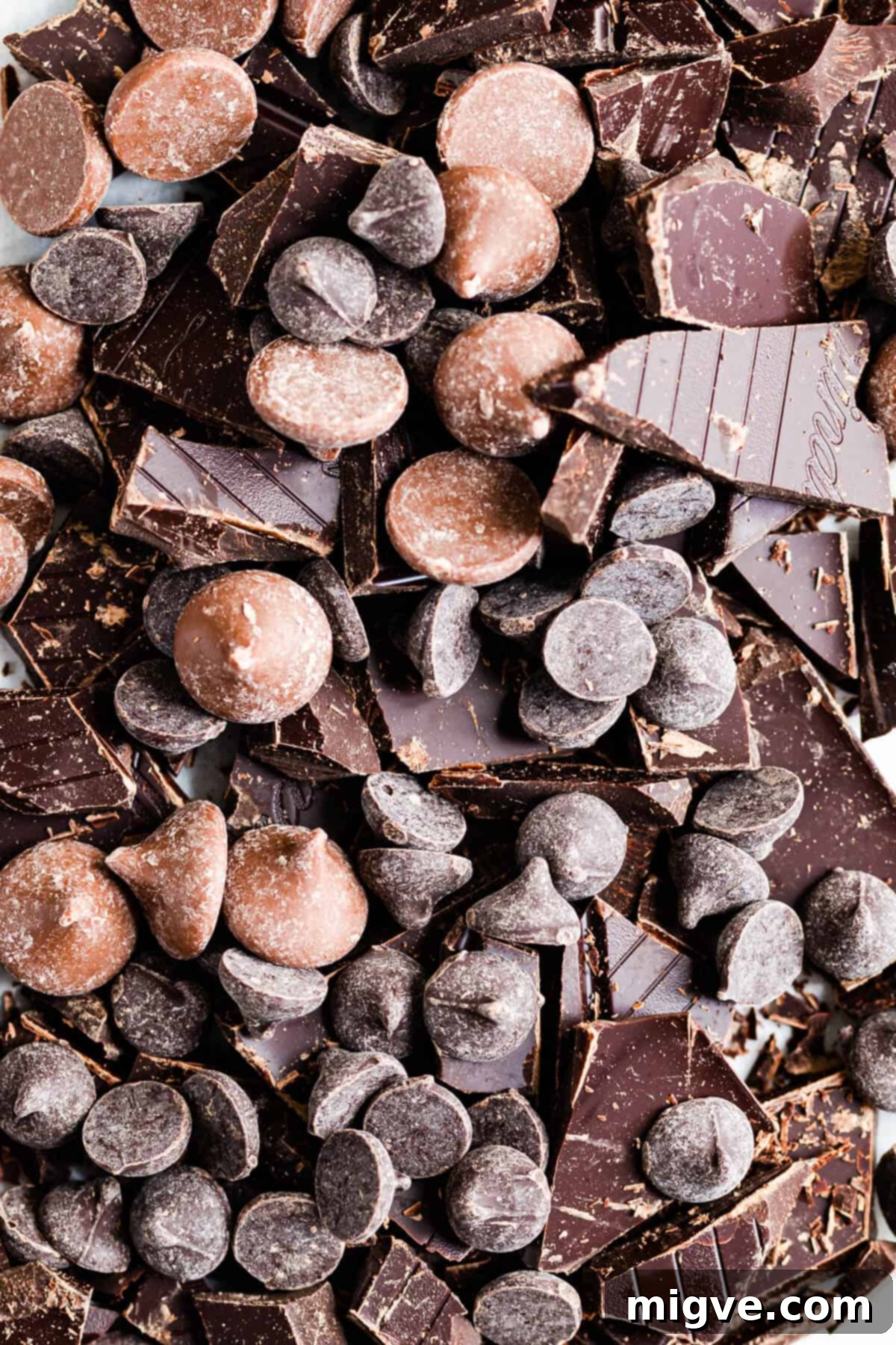 close up top view of chopped dark chocolate and chocolate chips, ready for baking
