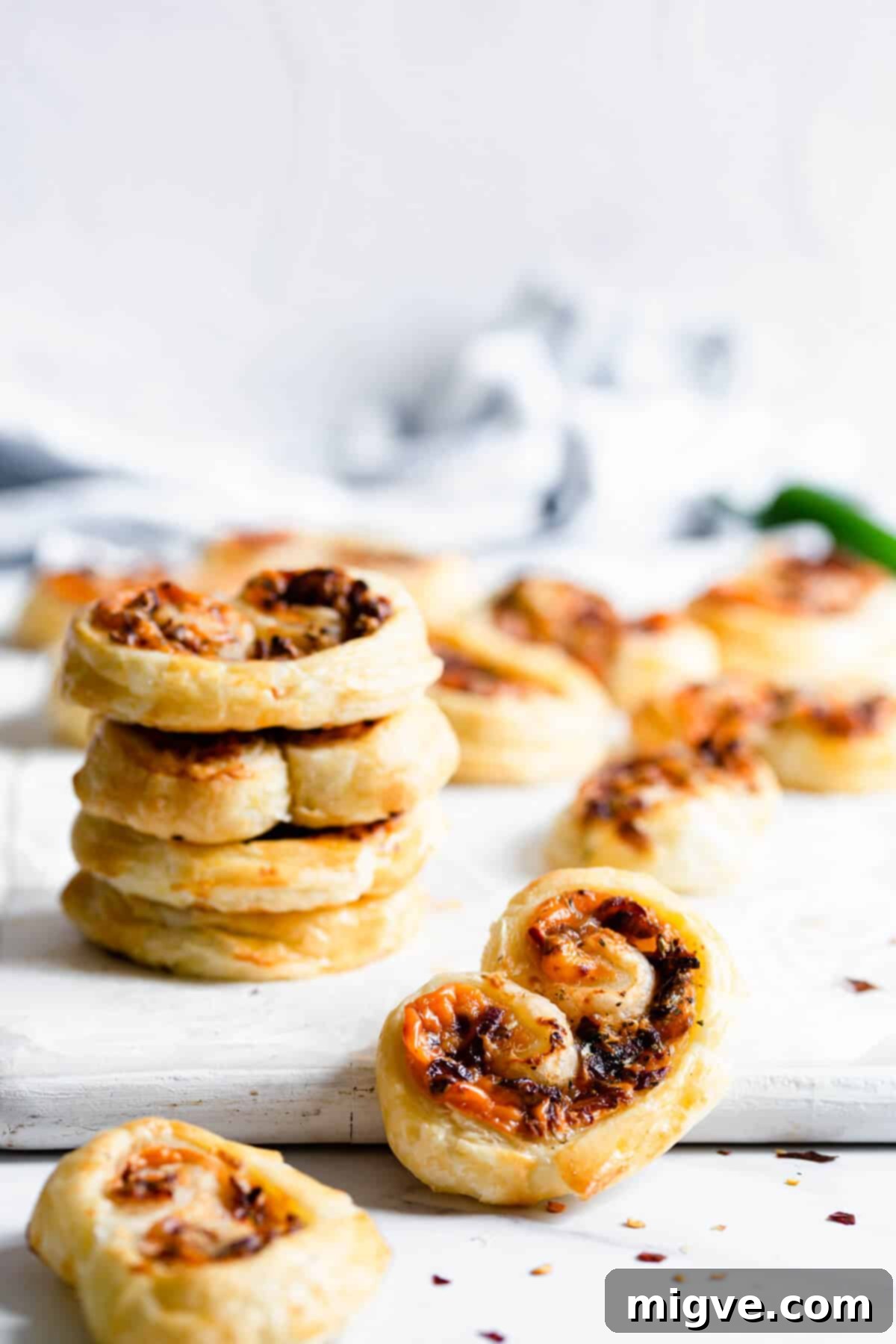 close up at puff pastry palmier filled with cream cheese and caramelised onion