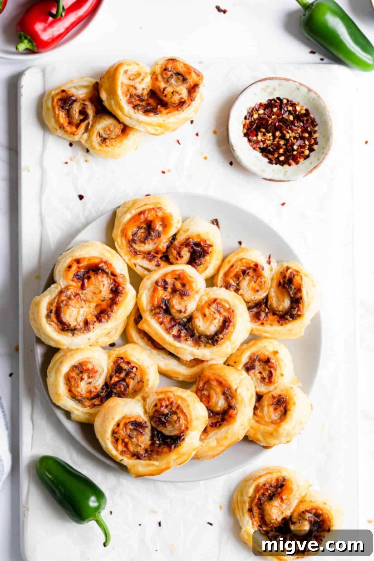 top view of a plate filled with cream cheese and caramelised onion palmiers 