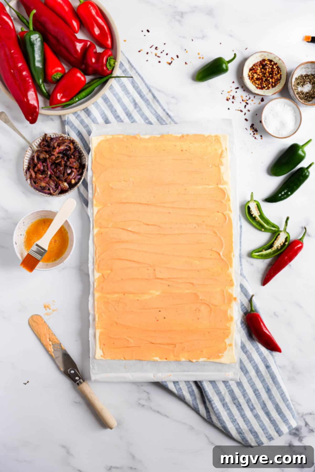 top view of puff pastry sheet with soft cheese spreaded all over it