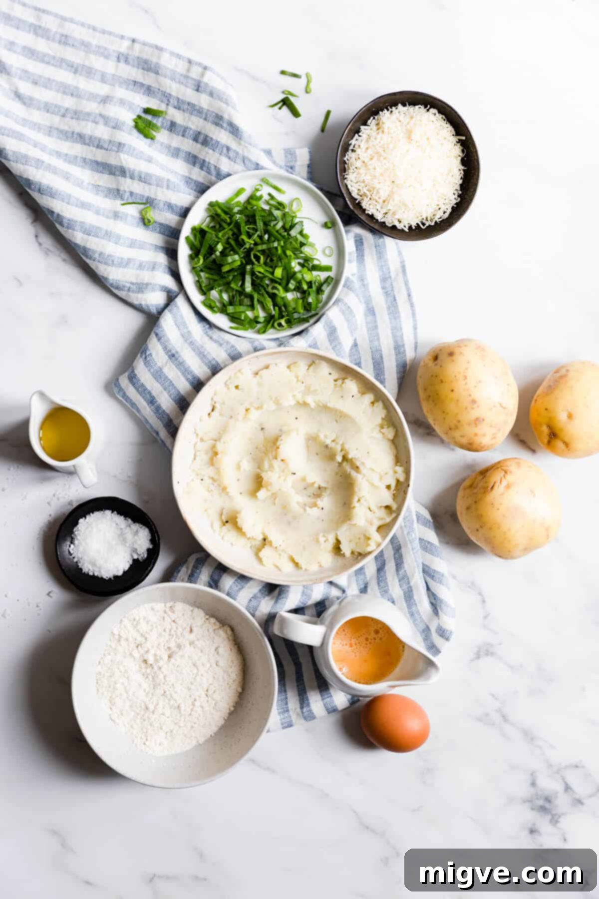 An overhead shot showcasing all the fresh and simple ingredients laid out for making delicious potato patties with chives.