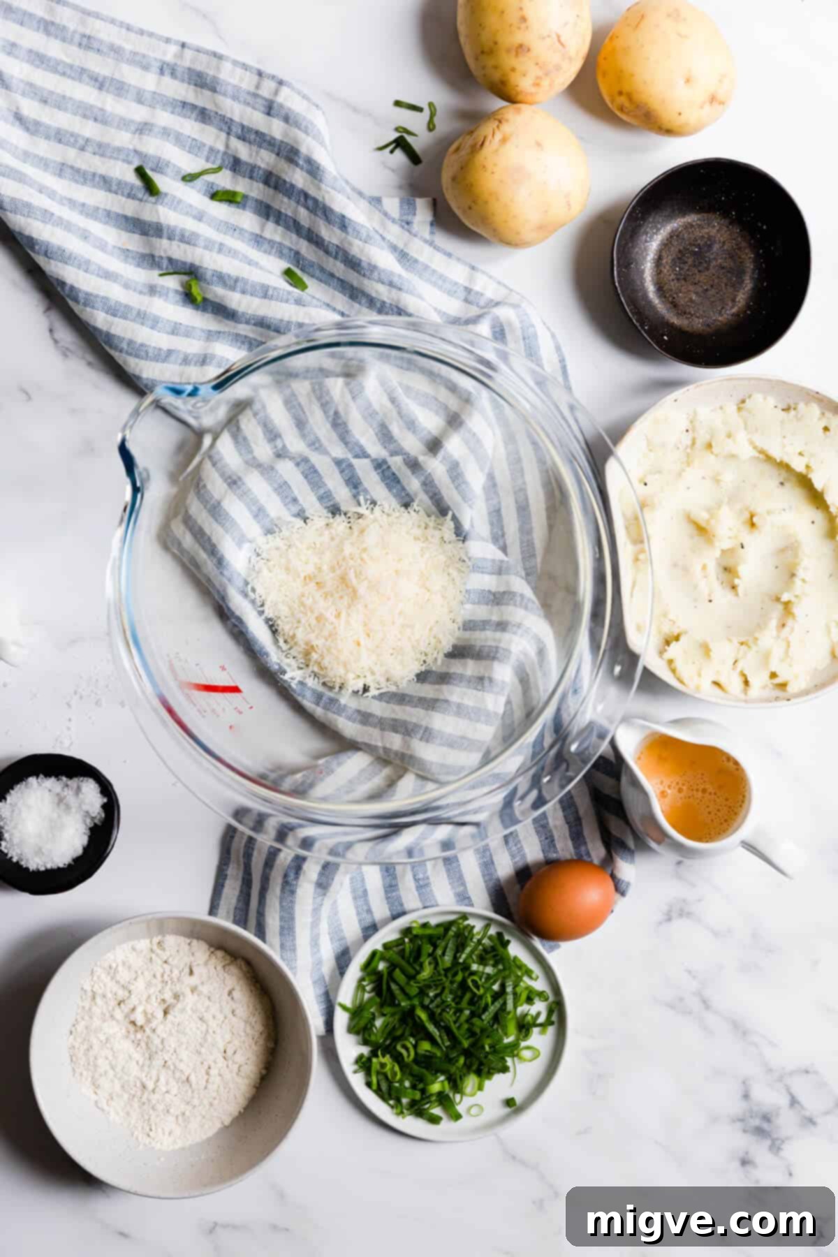 Overhead shot of a bowl with finely grated Parmesan cheese, ready for mixing.