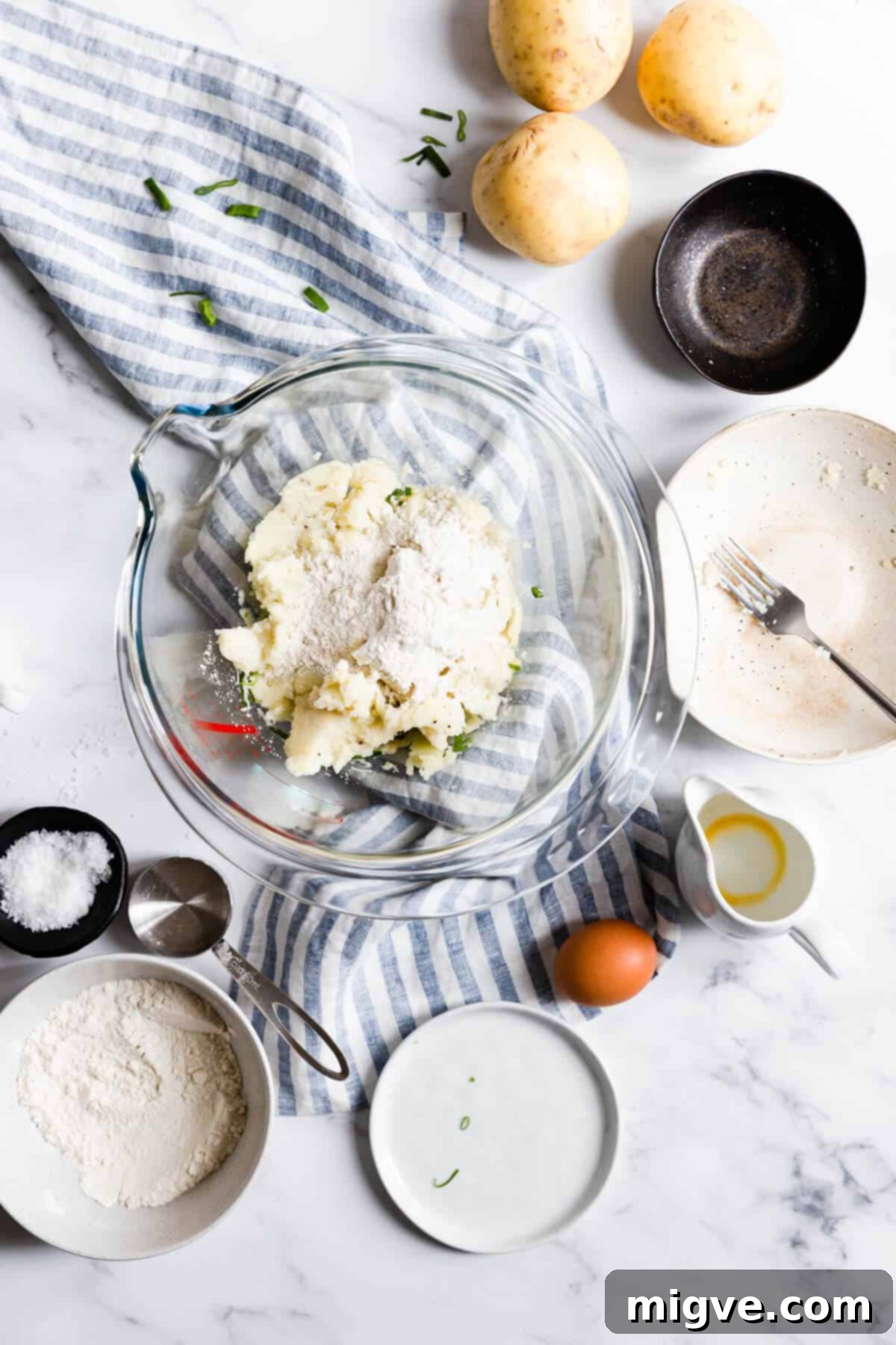 Overhead shot of a bowl filled with the fully combined mixture for potato patties, showing the texture and readiness for chilling.