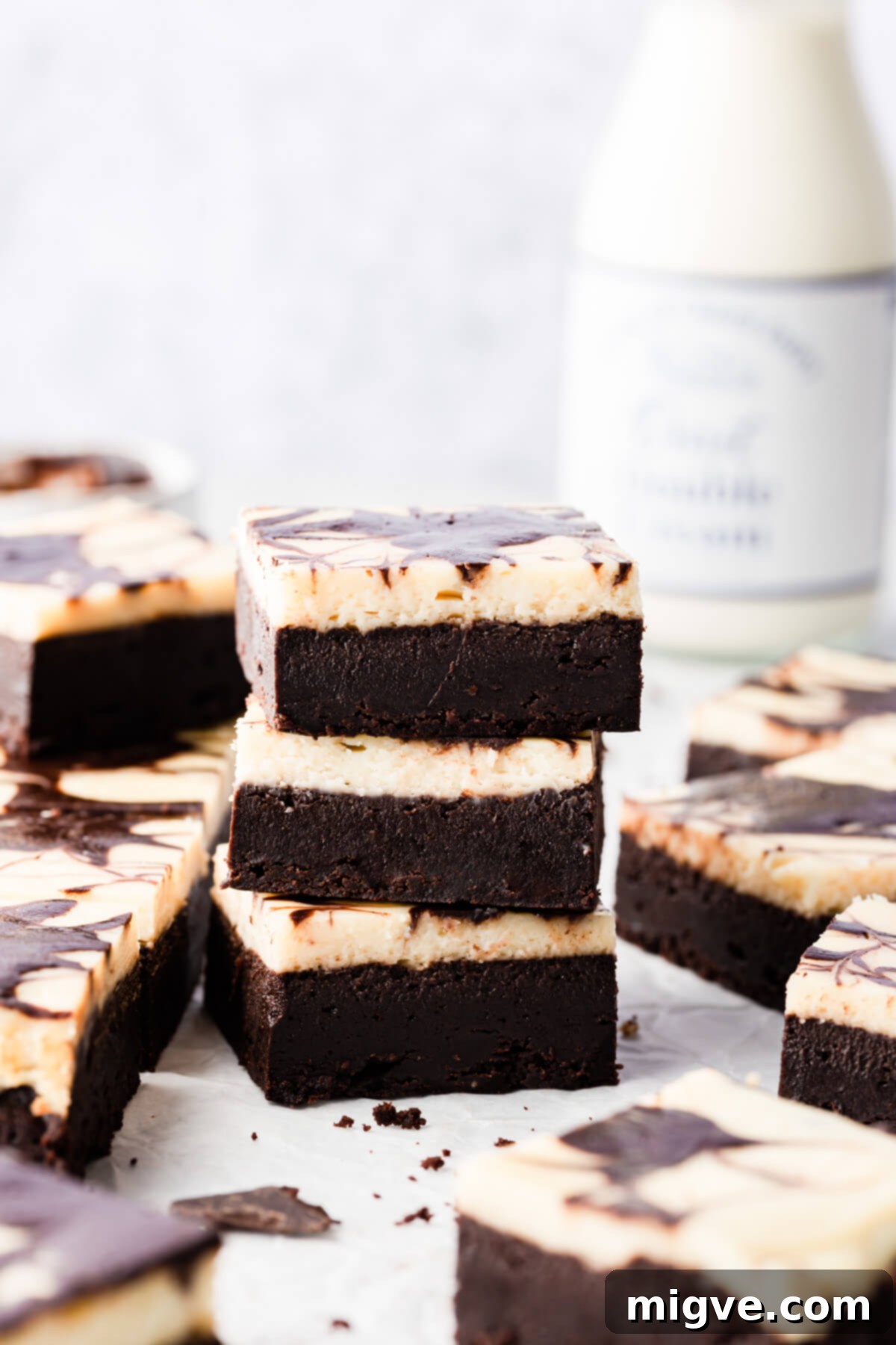 side super close up of 3 individual cream cheese brownies on top of each other