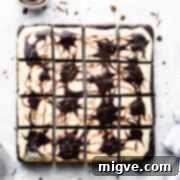 overhead shot of cheesecake topped brownies cut into 12 individual squares