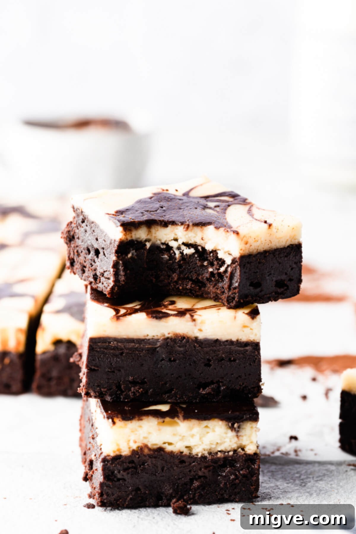 side close up of stack of brownies with the top one missing a bite