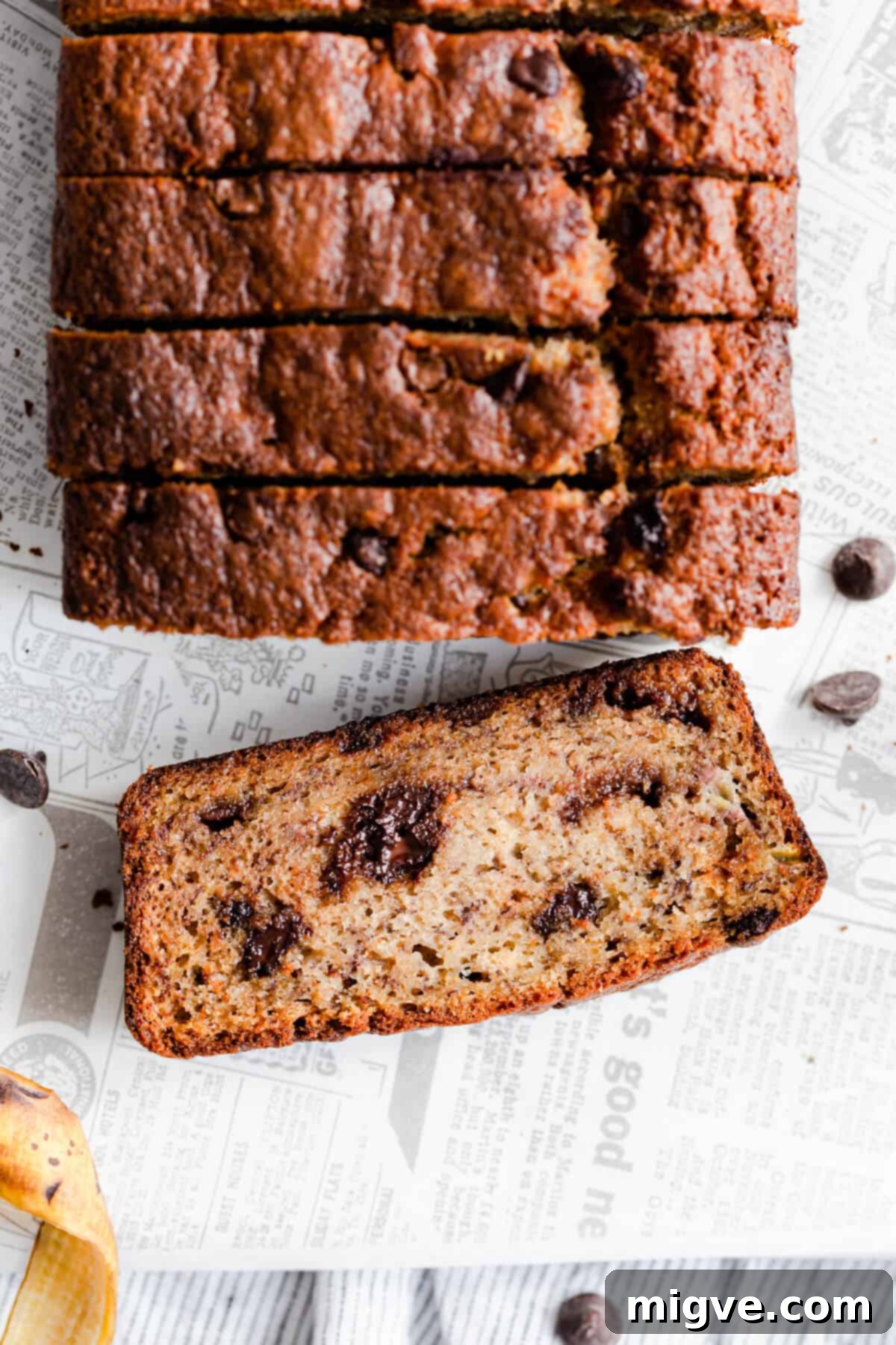 Close-up, top-down view showing a thick slice of chocolate chip banana bread, highlighting the perfect distribution of chocolate and its moist crumb.