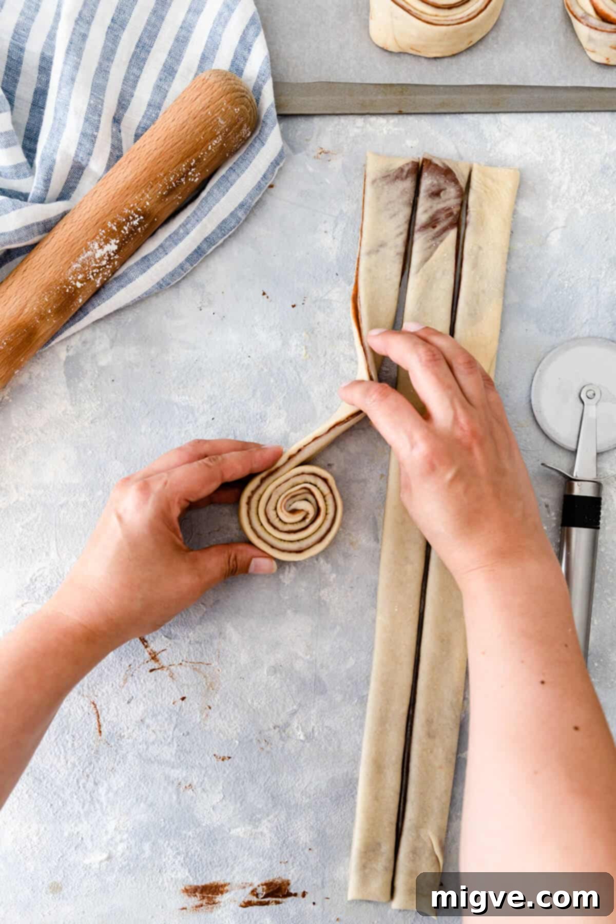 overhead shot showing dough being rolled into swirl