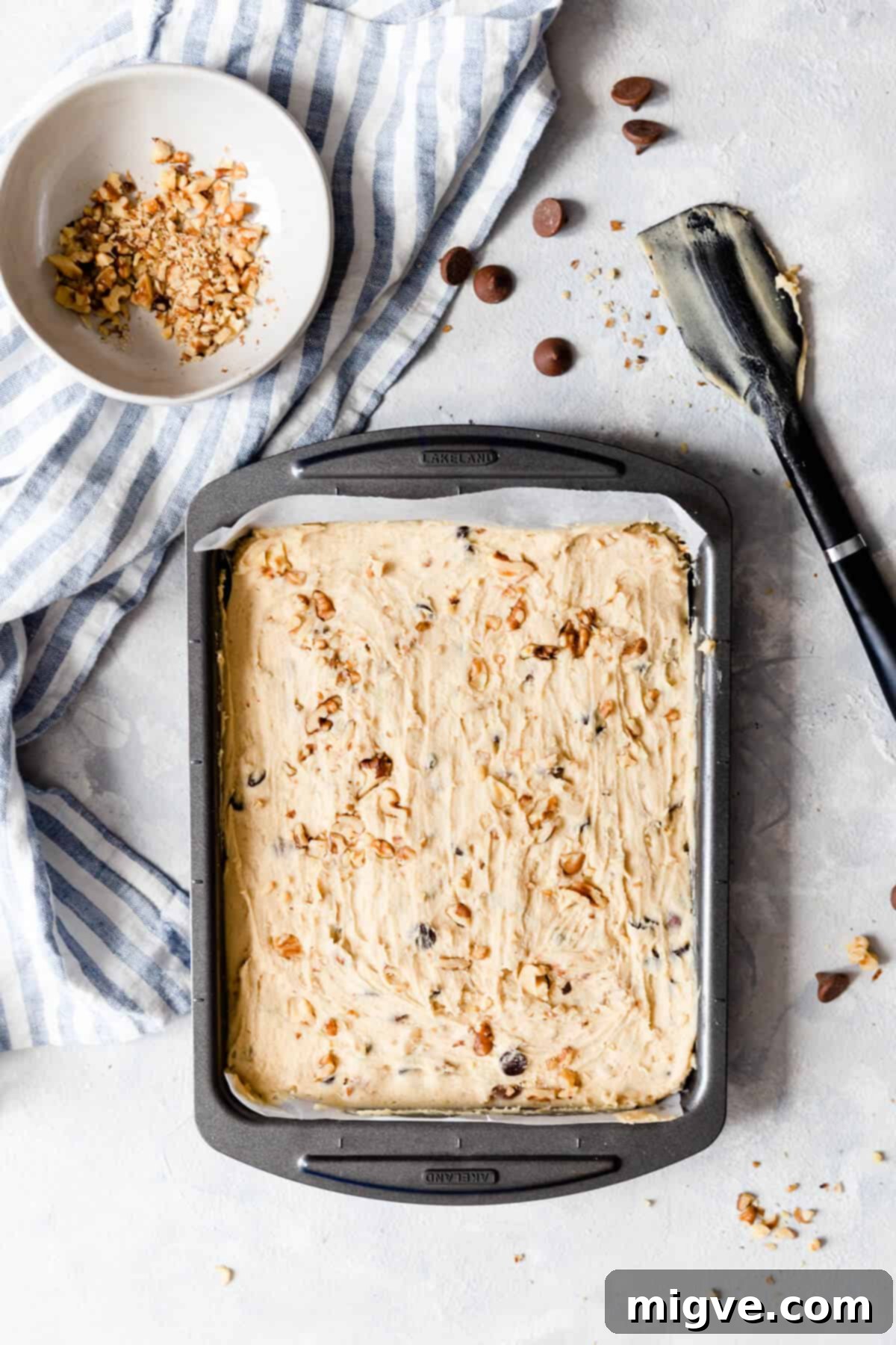 Chocolate Chip and Walnut Blondies 6 Top view of blondies batter evenly spread in a baking tin, ready for the oven