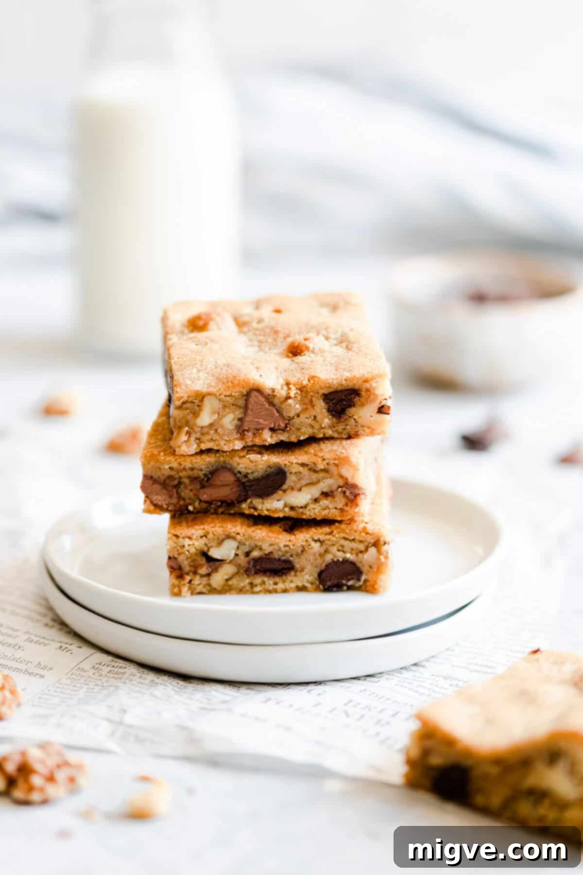 Chocolate Chip and Walnut Blondies 9 Side angle close-up of three decadent blondie bars stacked on top of each other