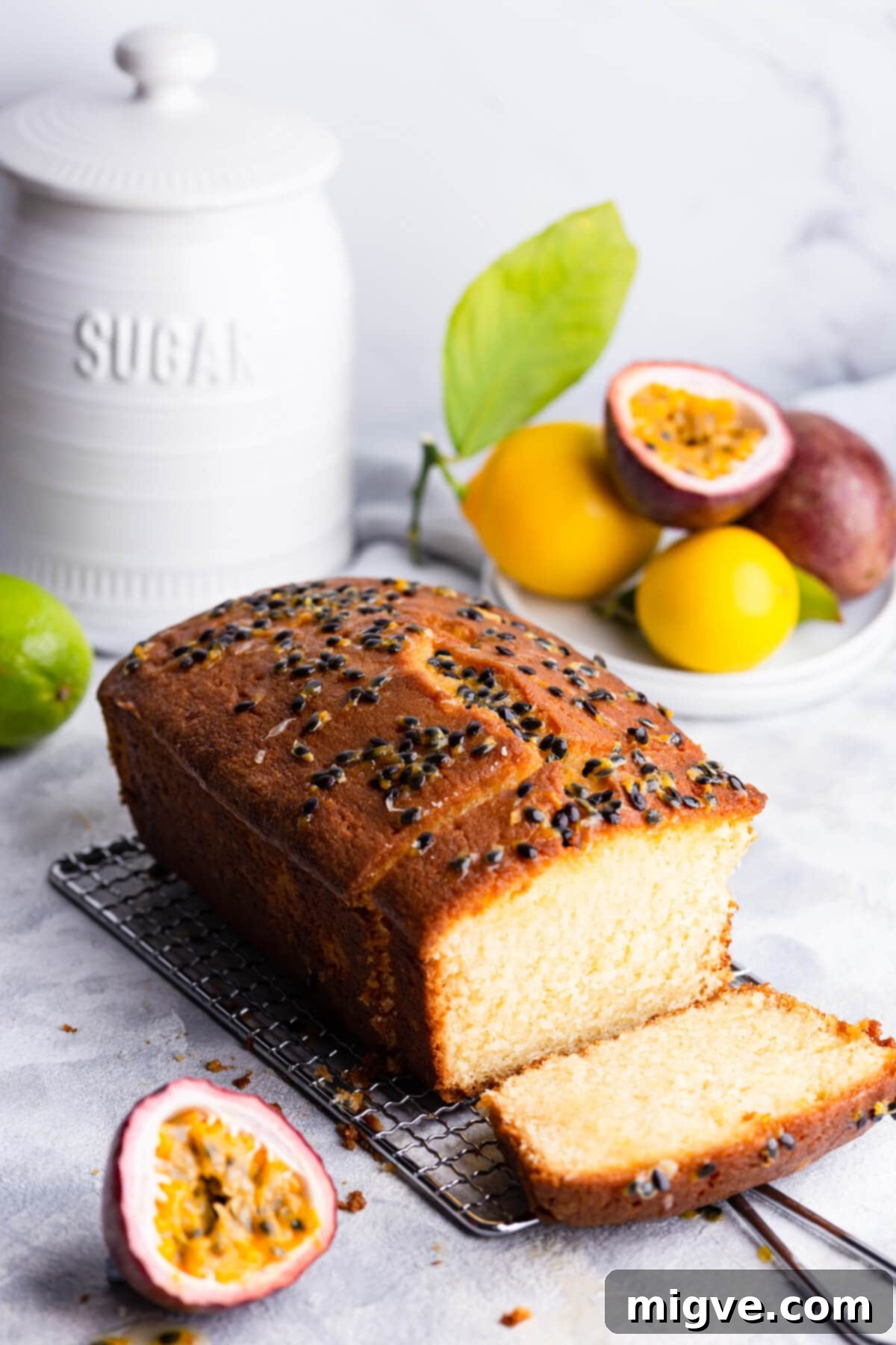 Tropical Passion Fruit Delight 11 A 45-degree angle view of a whole passion fruit loaf cake, beautifully topped with a glistening drizzle and crunchy sugared seeds