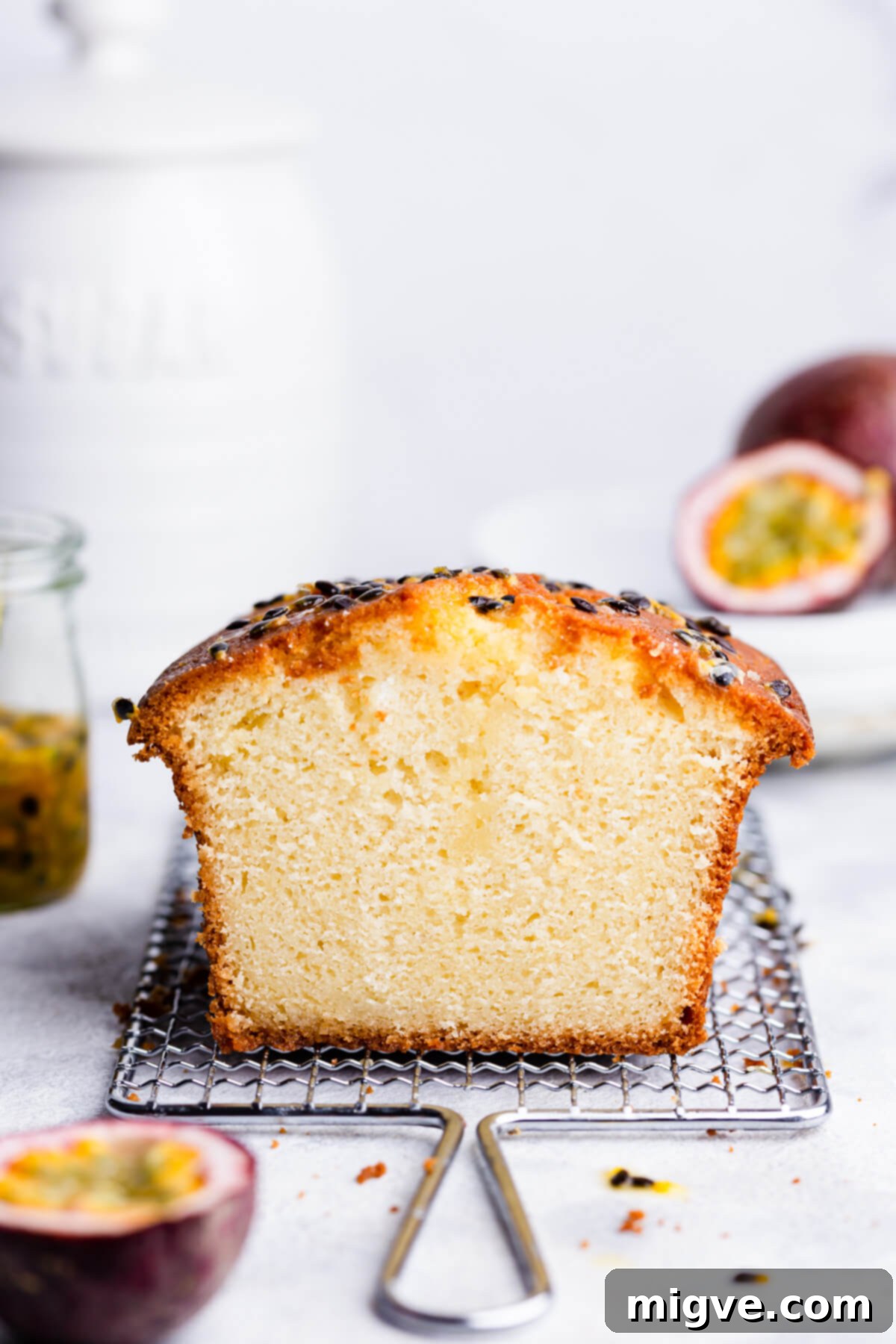 Tropical Passion Fruit Delight 12 A straight-ahead view of a beautiful passion fruit cake, generously topped with its vibrant drizzle and crunchy seeds