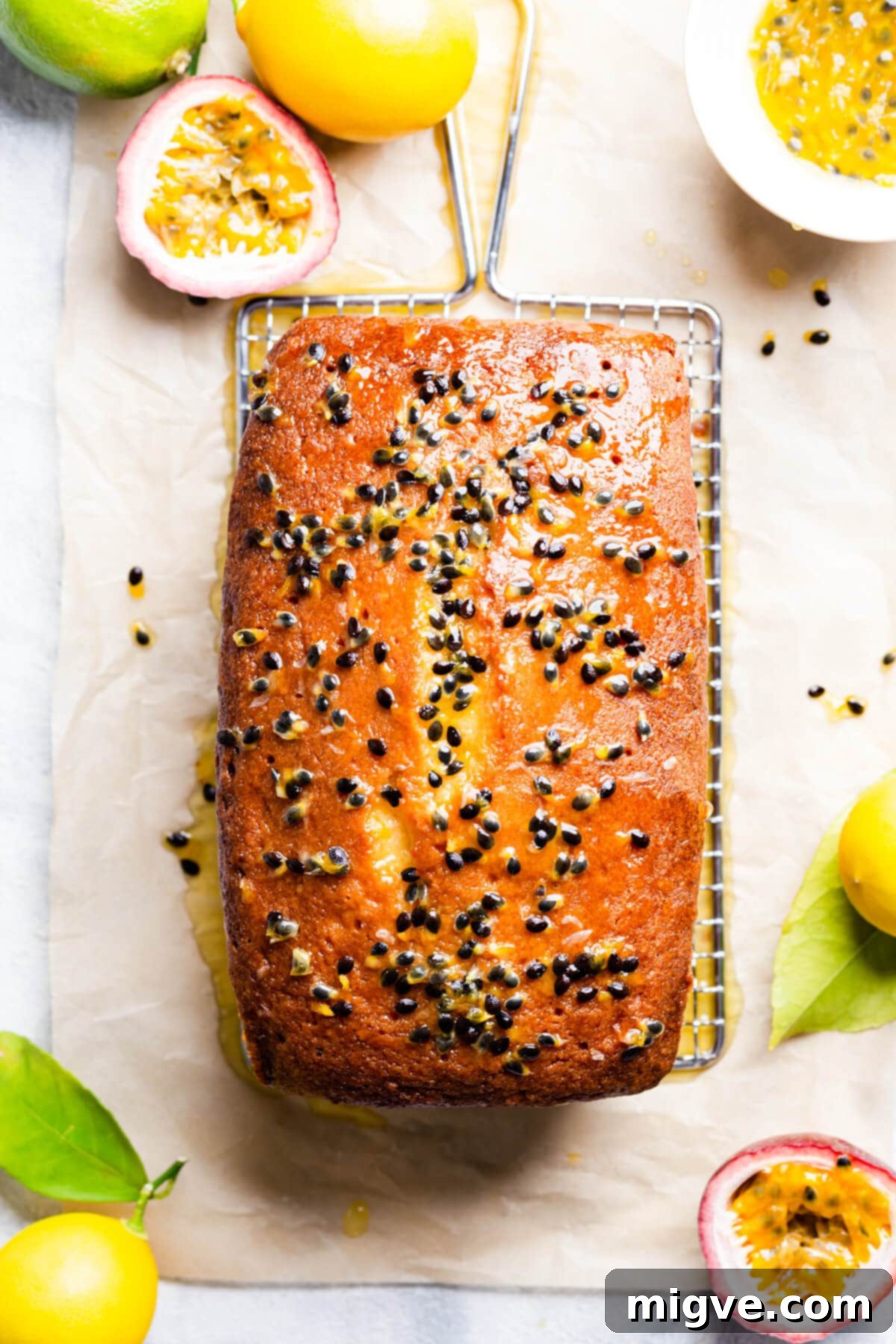 Tropical Passion Fruit Delight 7 Top-down view of a beautifully baked passion fruit sponge cake, glistening with its tropical drizzle and studded with crunchy seeds