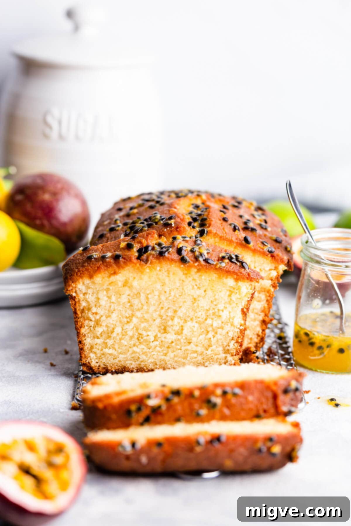 Tropical Passion Fruit Delight 8 Close-up, straight-ahead view of a generous slice of passion fruit drizzle cake, showing its moist interior and tempting sugared topping