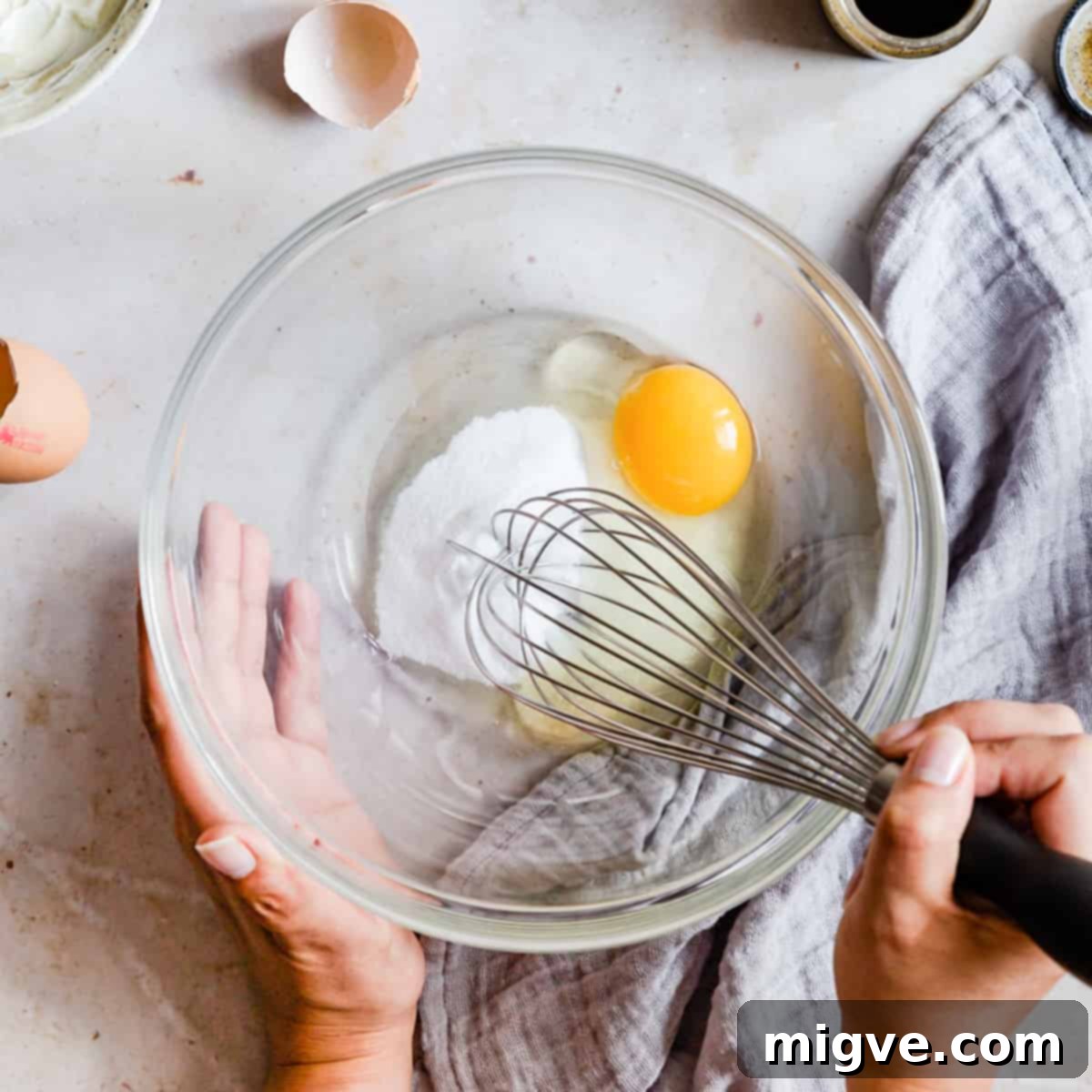Velvet Raspberry Mascarpone Tart 4 large glass mixing bowl with sugar and egg being whisked.