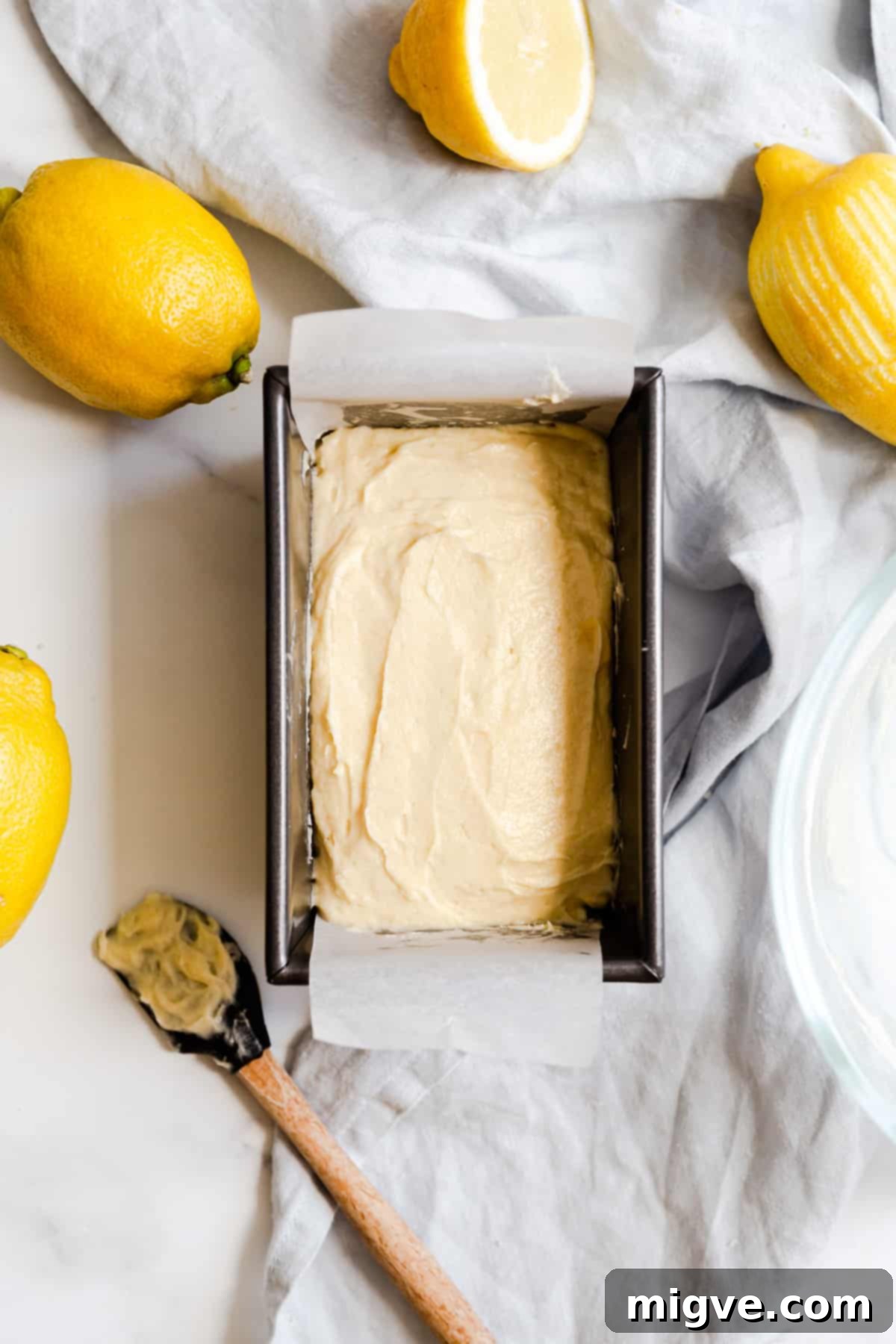 Zesty Small Batch Lemon Drizzle Cake 12 Overhead shot of lemon drizzle cake batter perfectly scooped into a baking tin, ready for the oven.