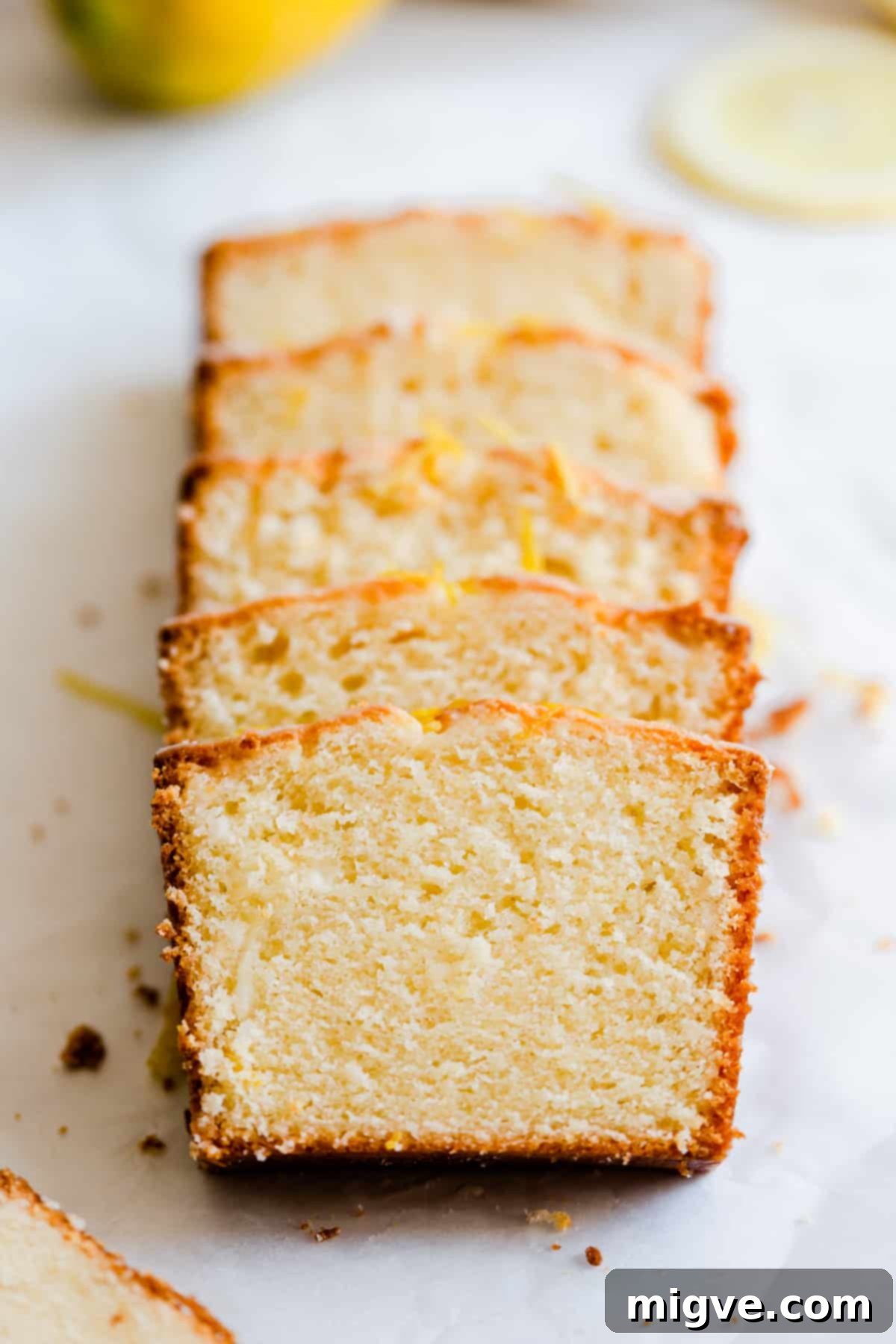 Zesty Small Batch Lemon Drizzle Cake 13 Close-up of several slices of perfectly baked small-batch lemon drizzle cake, showing the moist crumb and generous glaze.