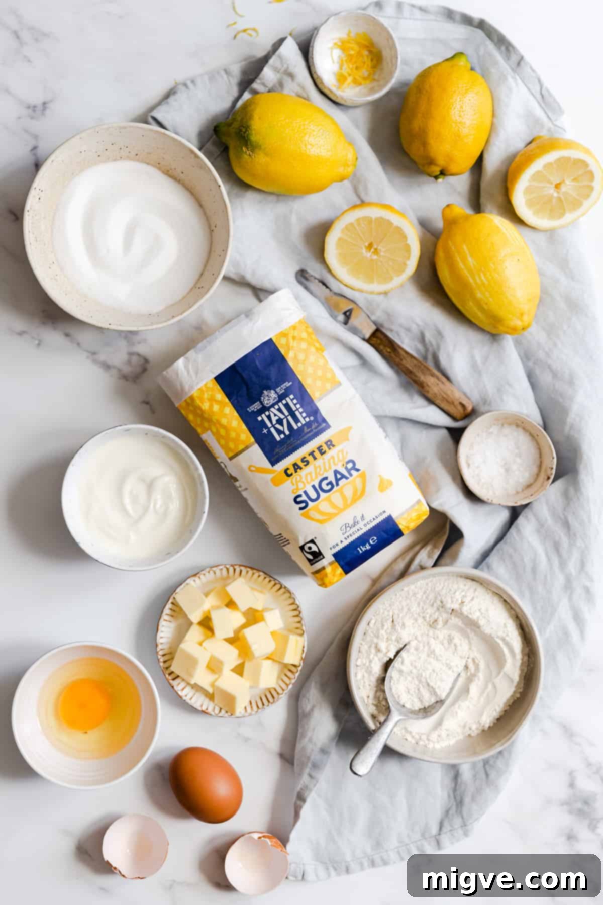 Zesty Small Batch Lemon Drizzle Cake 3 Overhead shot showcasing all the essential ingredients for making a small-batch lemon drizzle cake, neatly arranged for preparation.