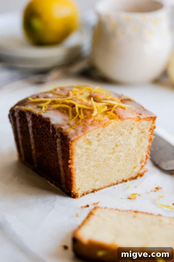 Zesty Small Batch Lemon Drizzle Cake 5 A side view of a perfectly baked small-batch lemon drizzle cake loaf, ready to be sliced and served.