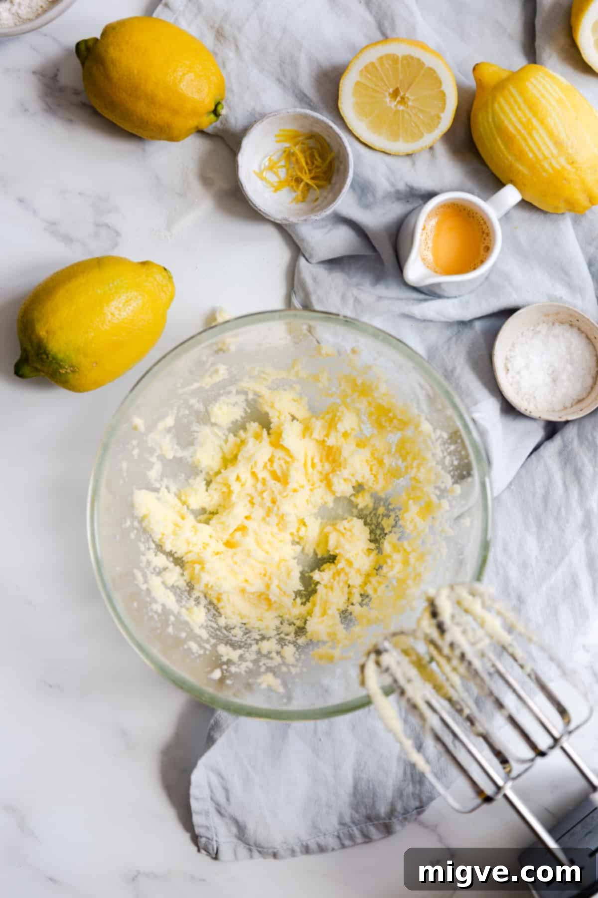 Zesty Small Batch Lemon Drizzle Cake 7 Top view of a mixing bowl containing beautifully creamed butter and sugar, now pale and fluffy, signifying proper aeration.