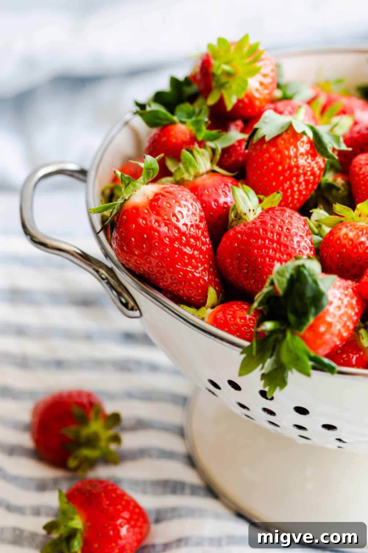 Effortless Strawberry Sunshine 3 side close up at fresh strawberries in colander