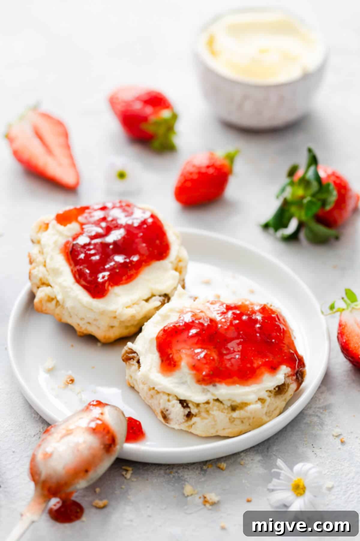 Effortless Strawberry Sunshine 4 side close up at scone with strawberry jam and cream