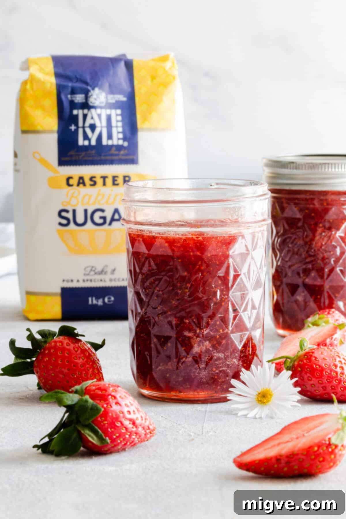 Effortless Strawberry Sunshine 5 straight ahead shot of open jar with strawberry jam inside and another jar in the back
