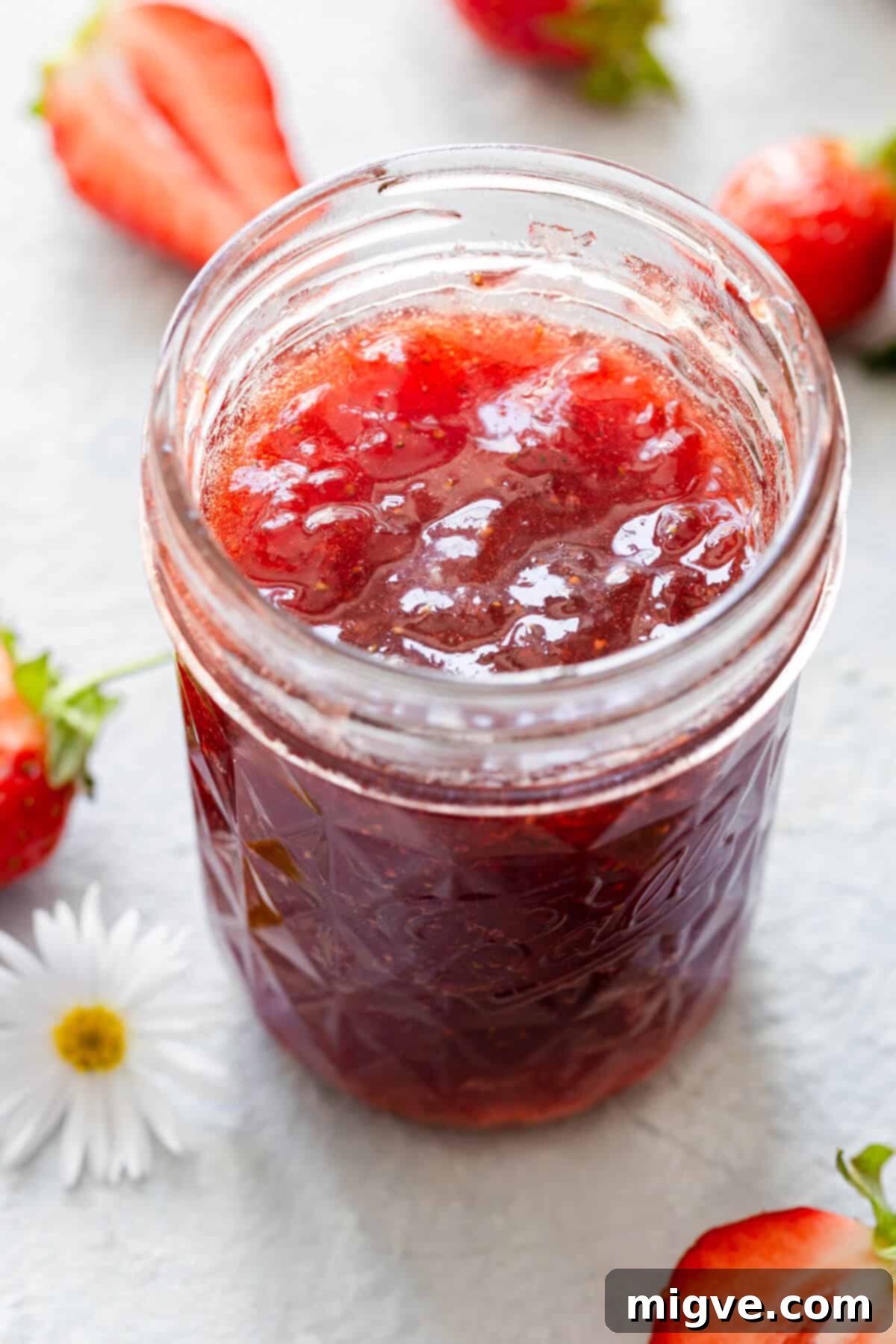 Effortless Strawberry Sunshine 8 top view side close up of open jar with jam inside