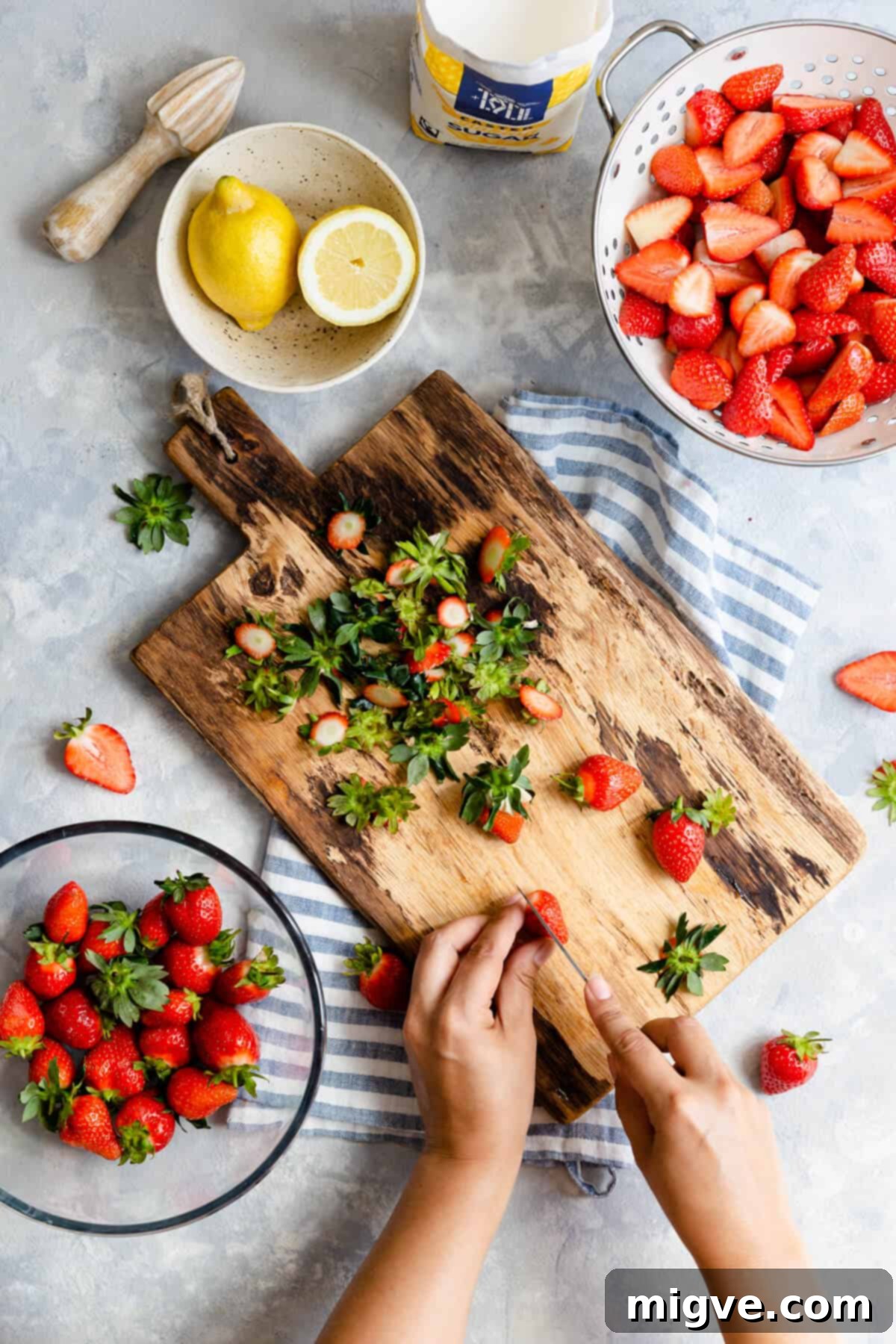 Effortless Strawberry Sunshine 10 overhead shot of a person slicing strawberries on a chopping board