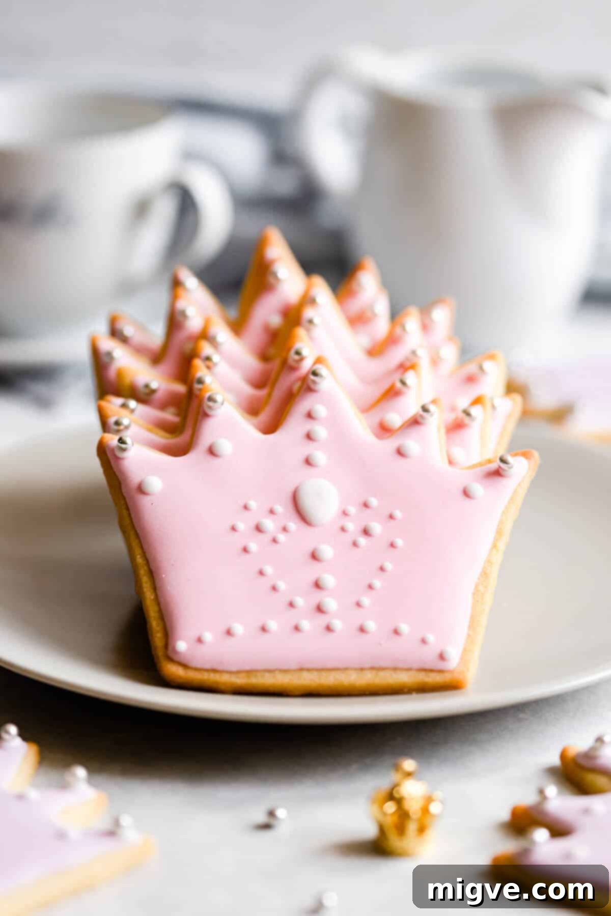Celebration Sugar Cookie Delights 2 Close-up of crown-shaped sugar cookies with elegant pink royal icing, ready to be a perfect birthday treat or gift.