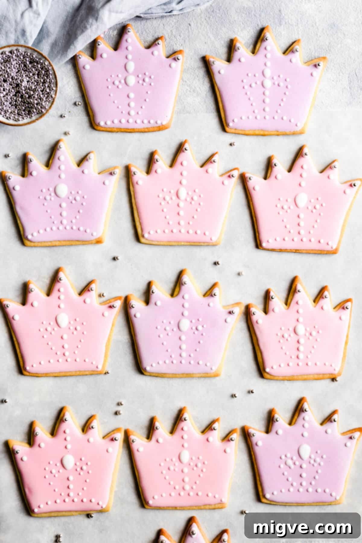 Celebration Sugar Cookie Delights 3 Overhead view of an assortment of birthday sugar cookies, intricately decorated with vibrant pink and purple royal icing.