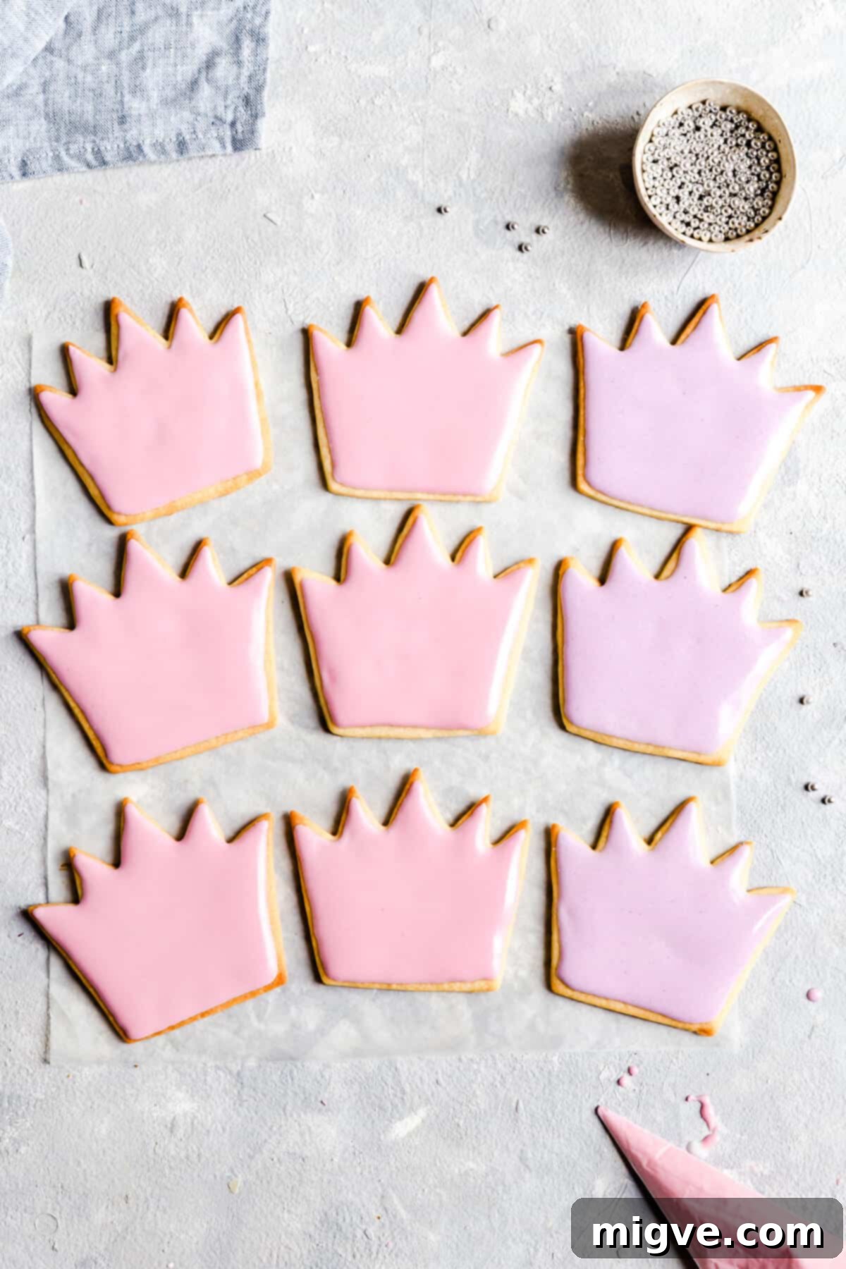 Celebration Sugar Cookie Delights 7 An inviting overhead shot of birthday sugar cookies, beautifully adorned with pink and purple royal icing designs.