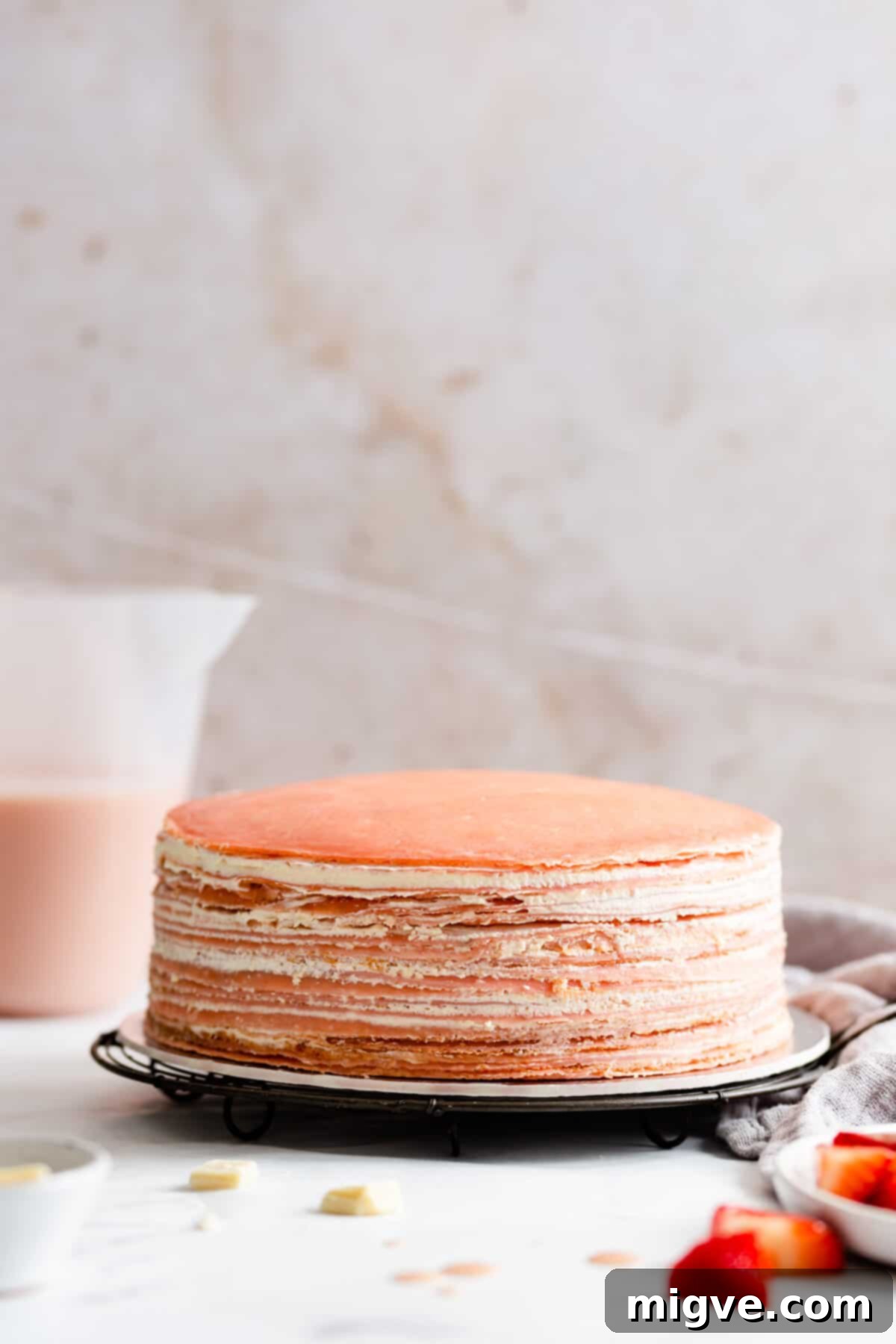 straight ahead shot of naked crepe cake with whipped cream