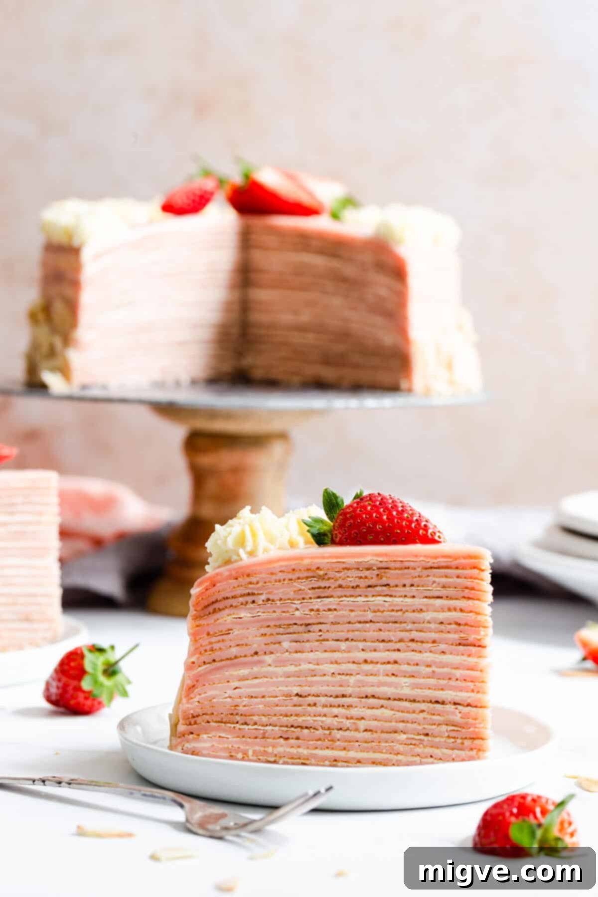 super close up straight ahead angle of a slice of crepe cake with cake in the background